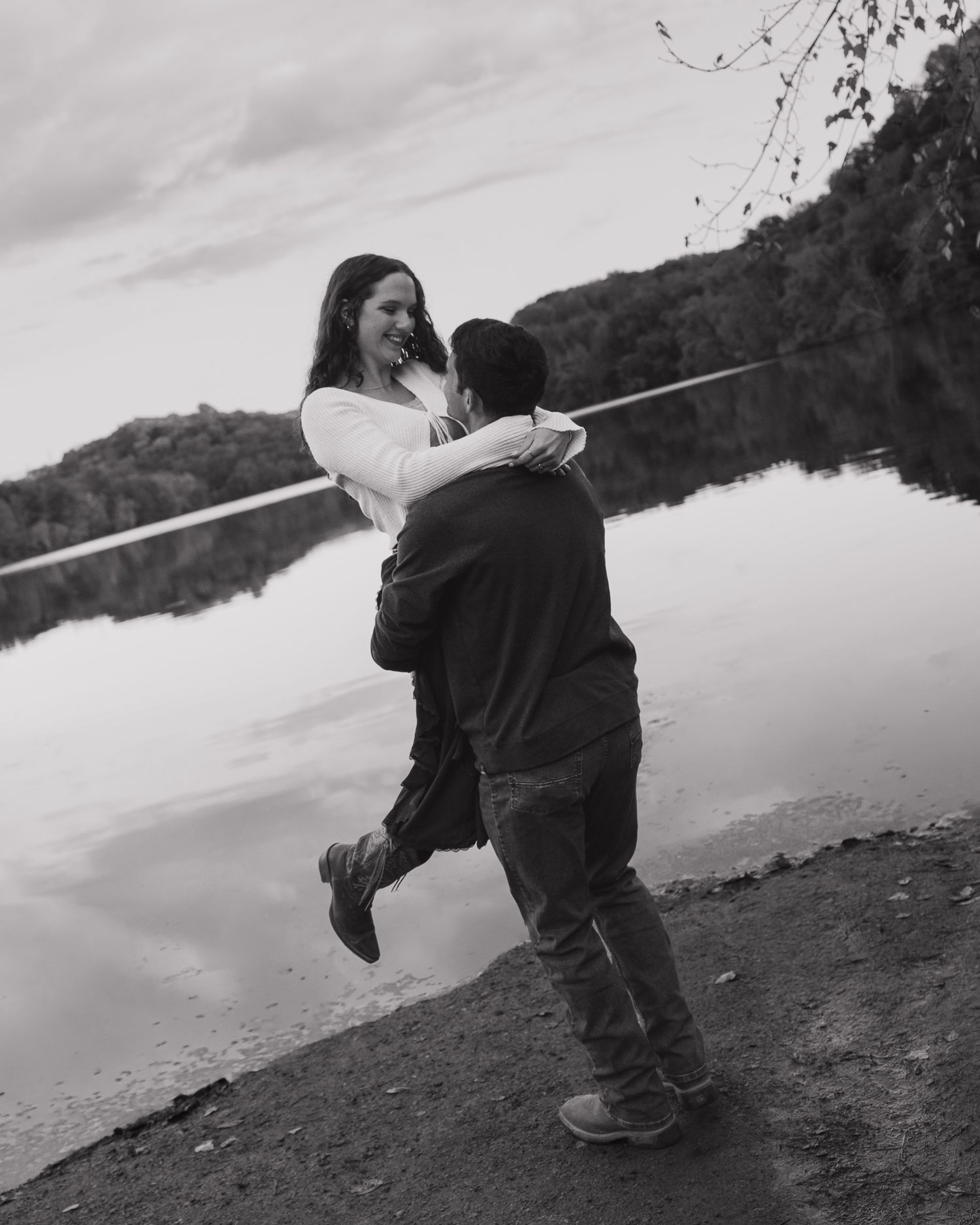 Black and white artistic photo sequence showing a couple by a reflective lake.