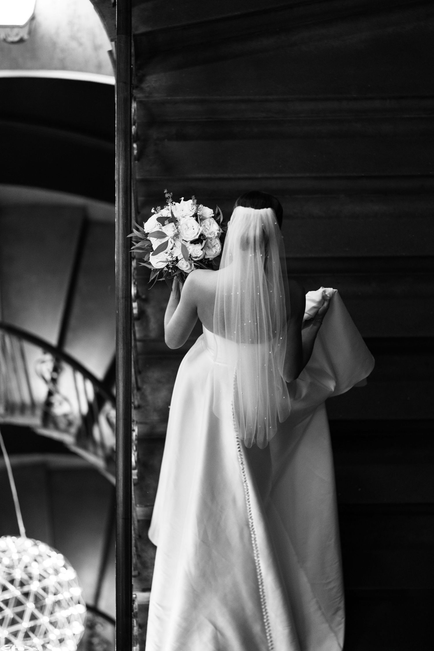 Brides dress captured editorially on staircase at Manchester Hall by Manchester wedding photographer Tina Hevingham.