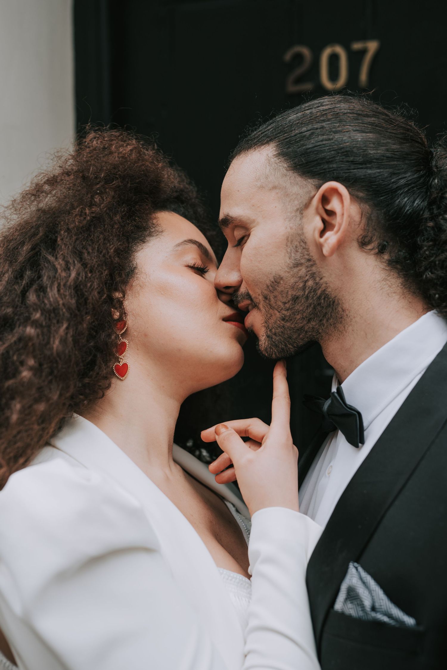 bride and groom kissing naturally captured by Manchester wedding photographer.