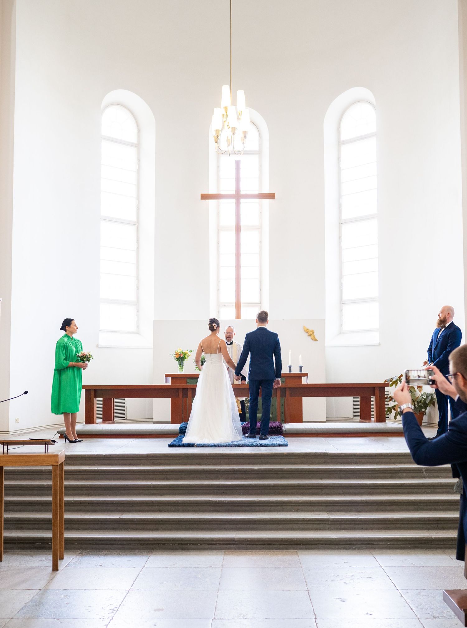 Bride and groom standing at the church altar during their wedding ceremony.