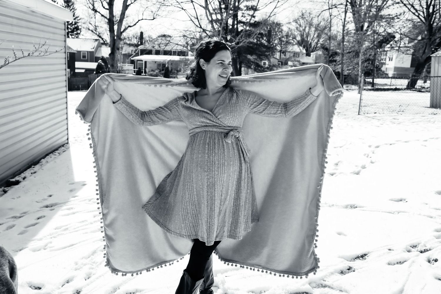 Person in flowing dress twirling in snowy outdoor setting.