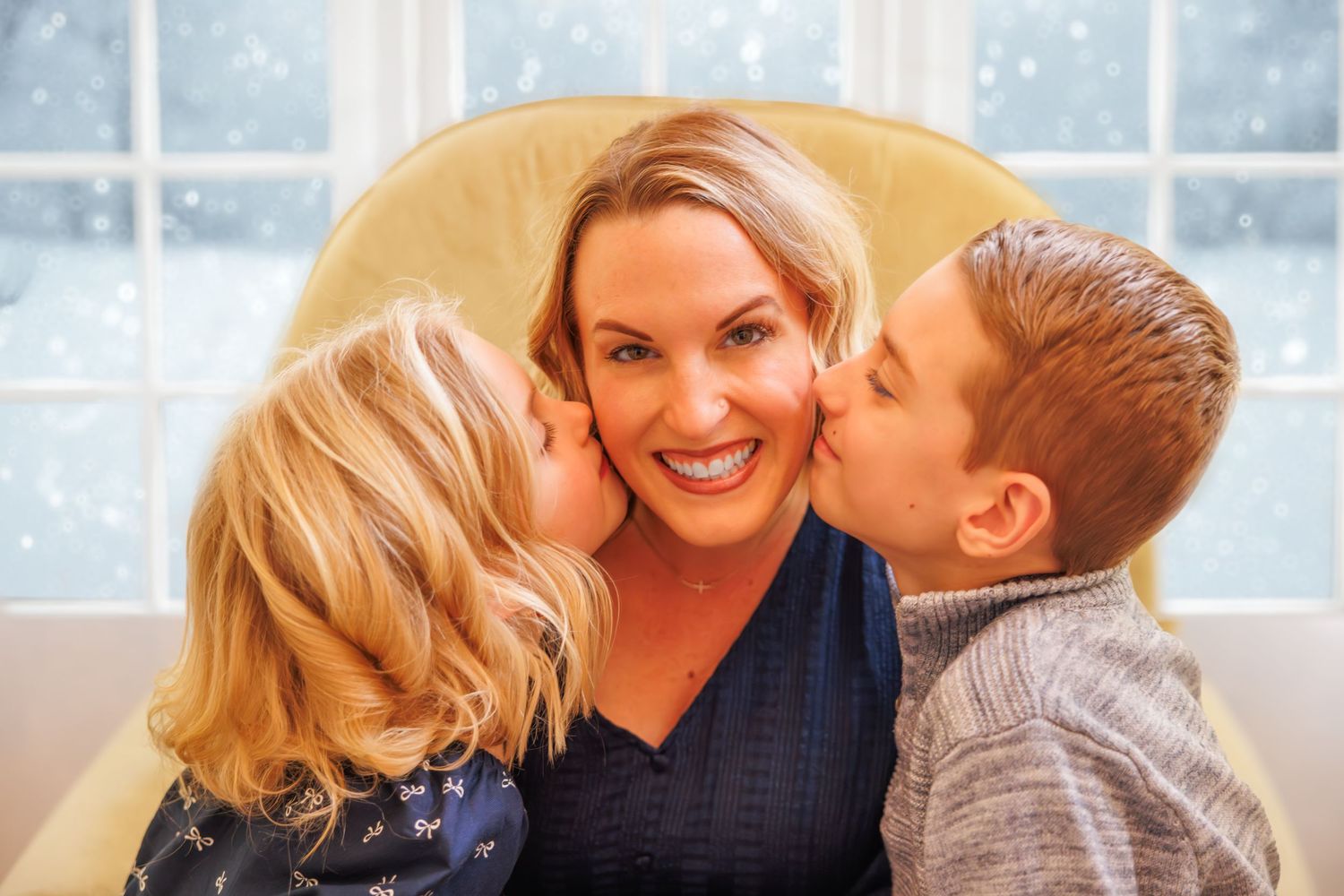 Family enjoying tender holiday moment by window with snowy scene outside.