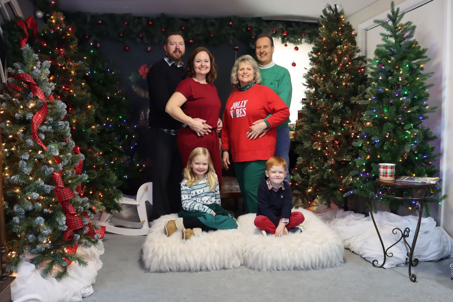 A festive Christmas scene with decorated trees, red ornaments, and white faux snow along the bottom.