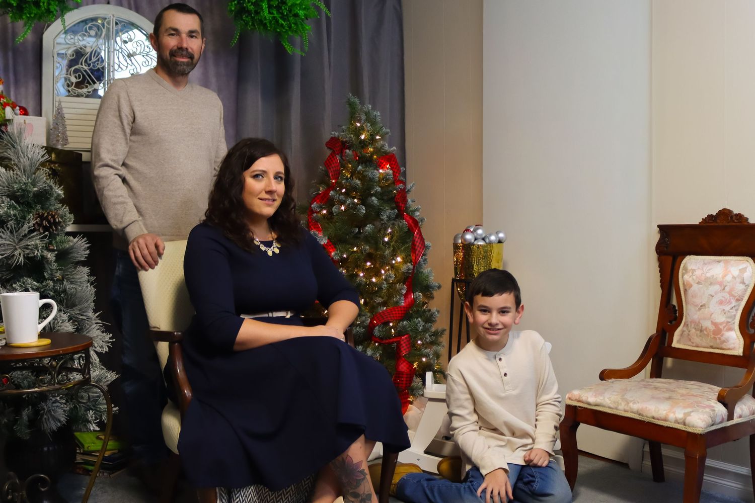 Family gathering in living room with Christmas decorations and holiday ambiance.