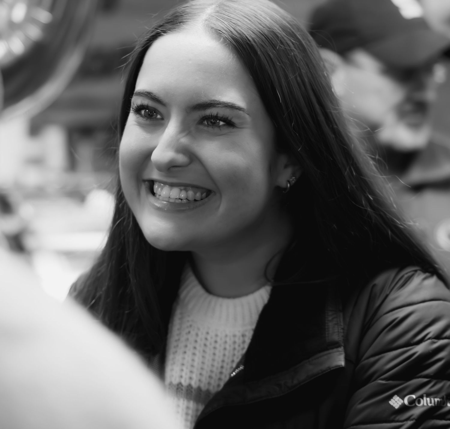 A series of black and white portraits showing expressions and smiles.
