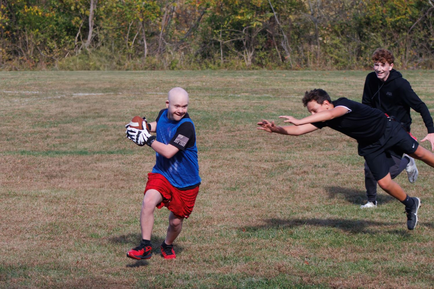 Athletes practicing soccer drills and passing techniques on a grassy field during training.