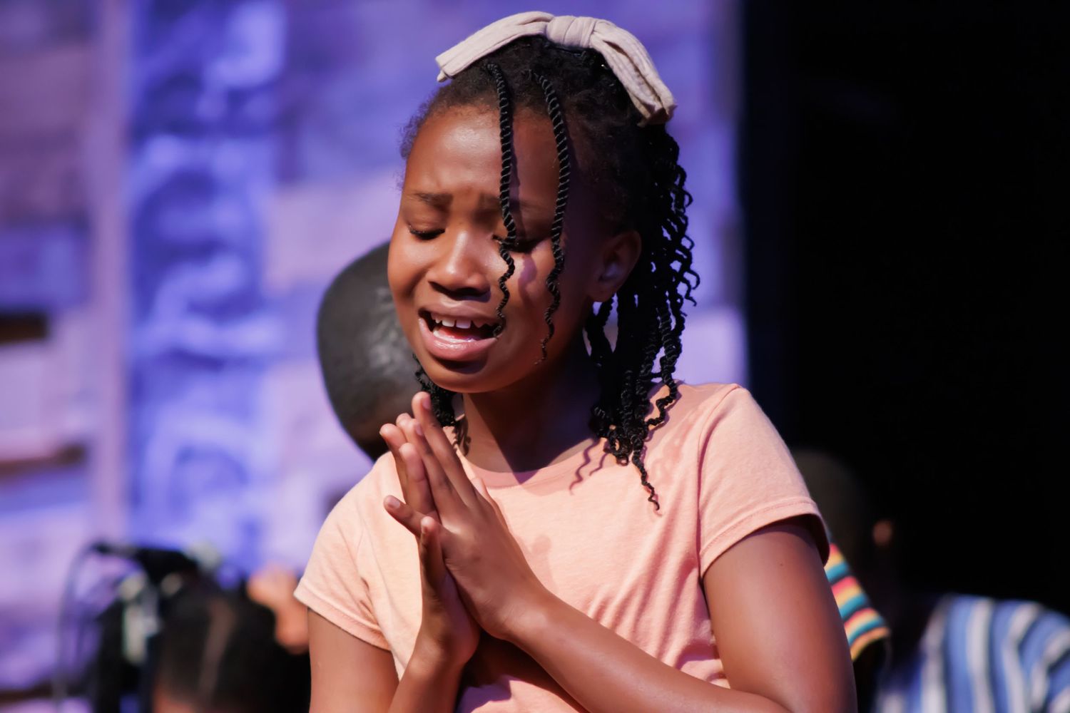 Performers sharing joyful moments during a stage production.