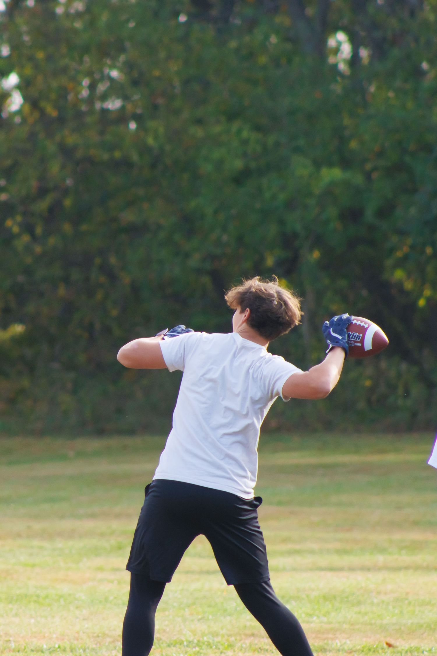 A sequence of flag football moves shown on a grassy field during practice.