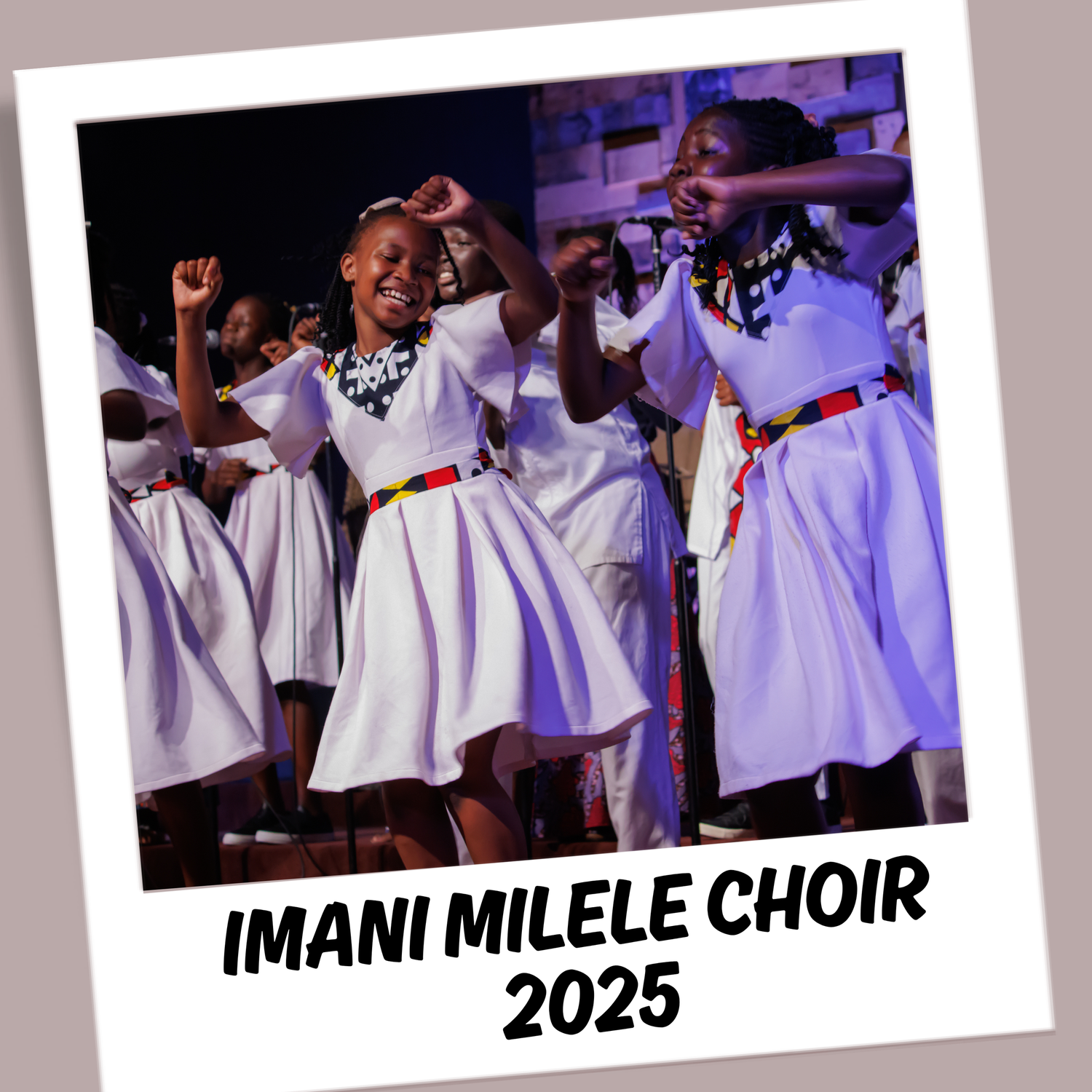Choir performers wearing white robes singing together on stage under stage lighting.