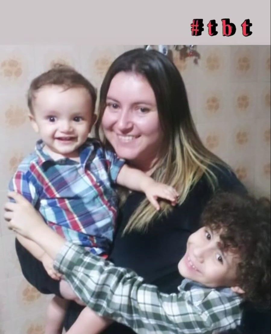 Family portrait showing joyful moments between parent and children on a patterned wallpaper background.
