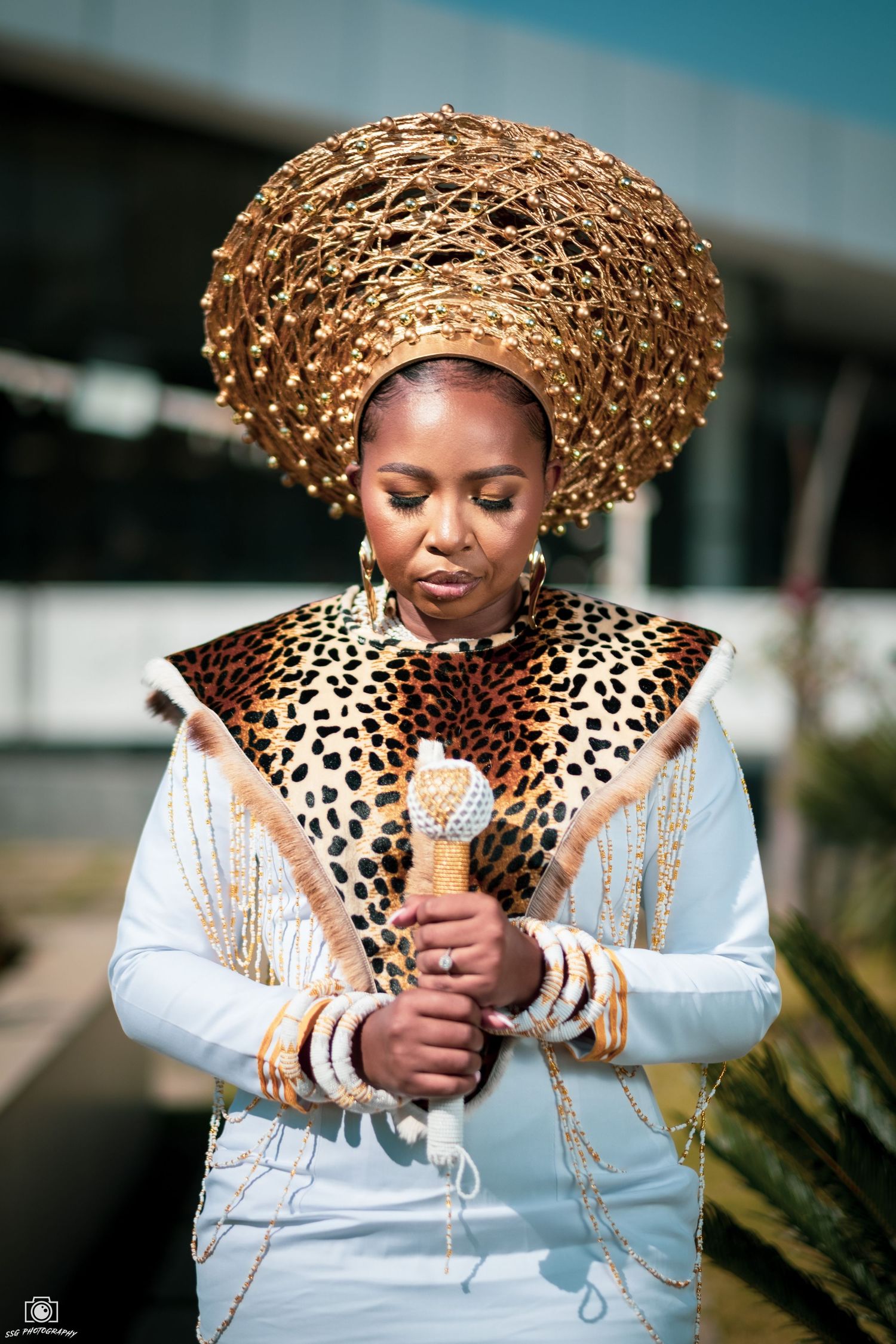 Elegant portrait series with a gold crown headpiece and leopard print details on white attire.