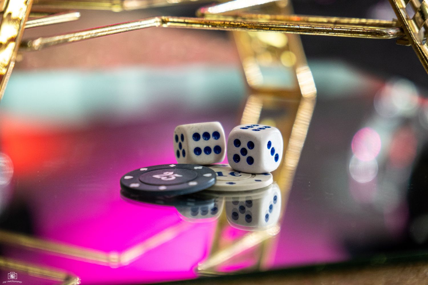 Casino-themed party setup with dice and playing card decorations in vibrant lighting.