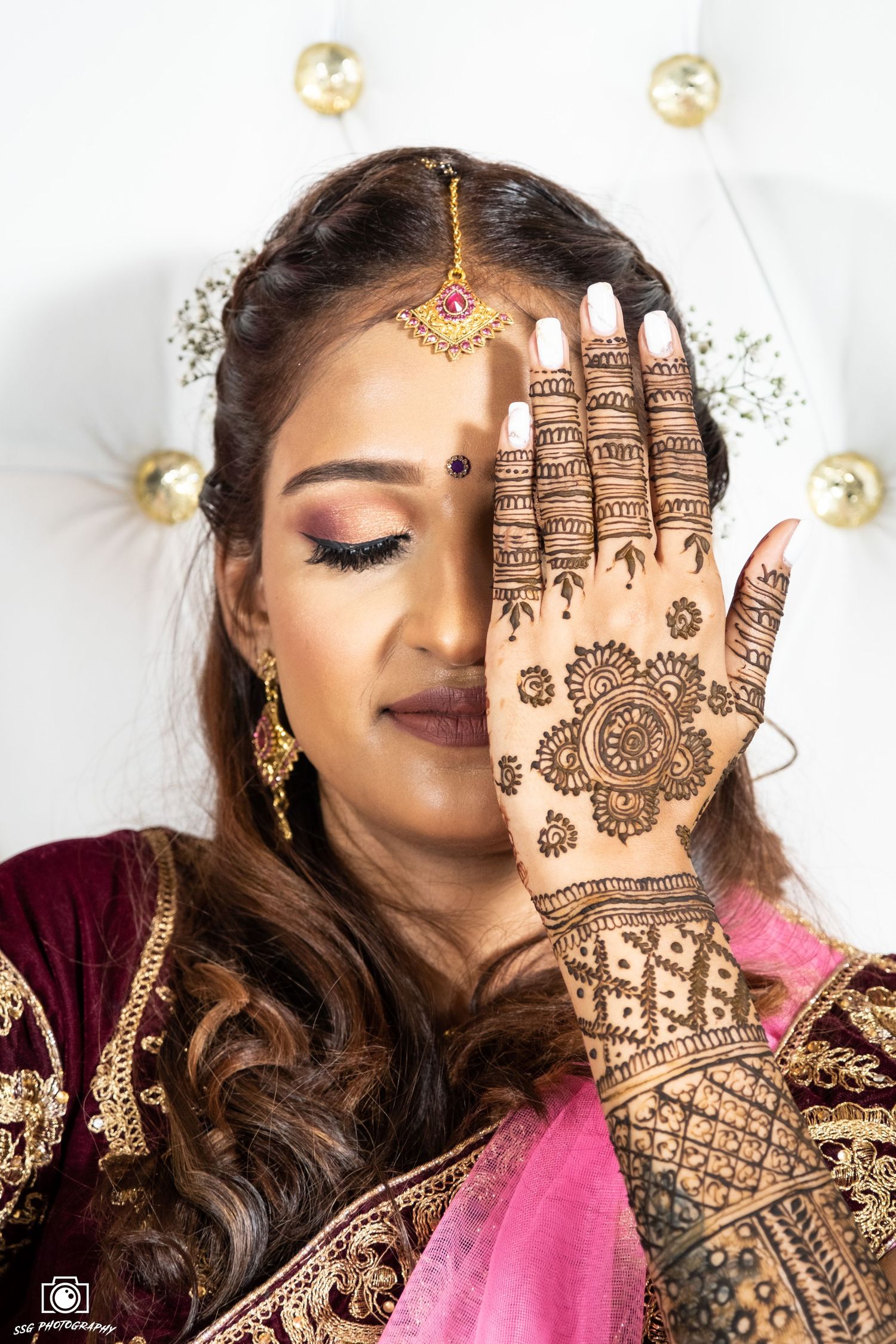 Bridal portraits showing detailed mehndi designs on hands with traditional Indian jewelry and makeup.