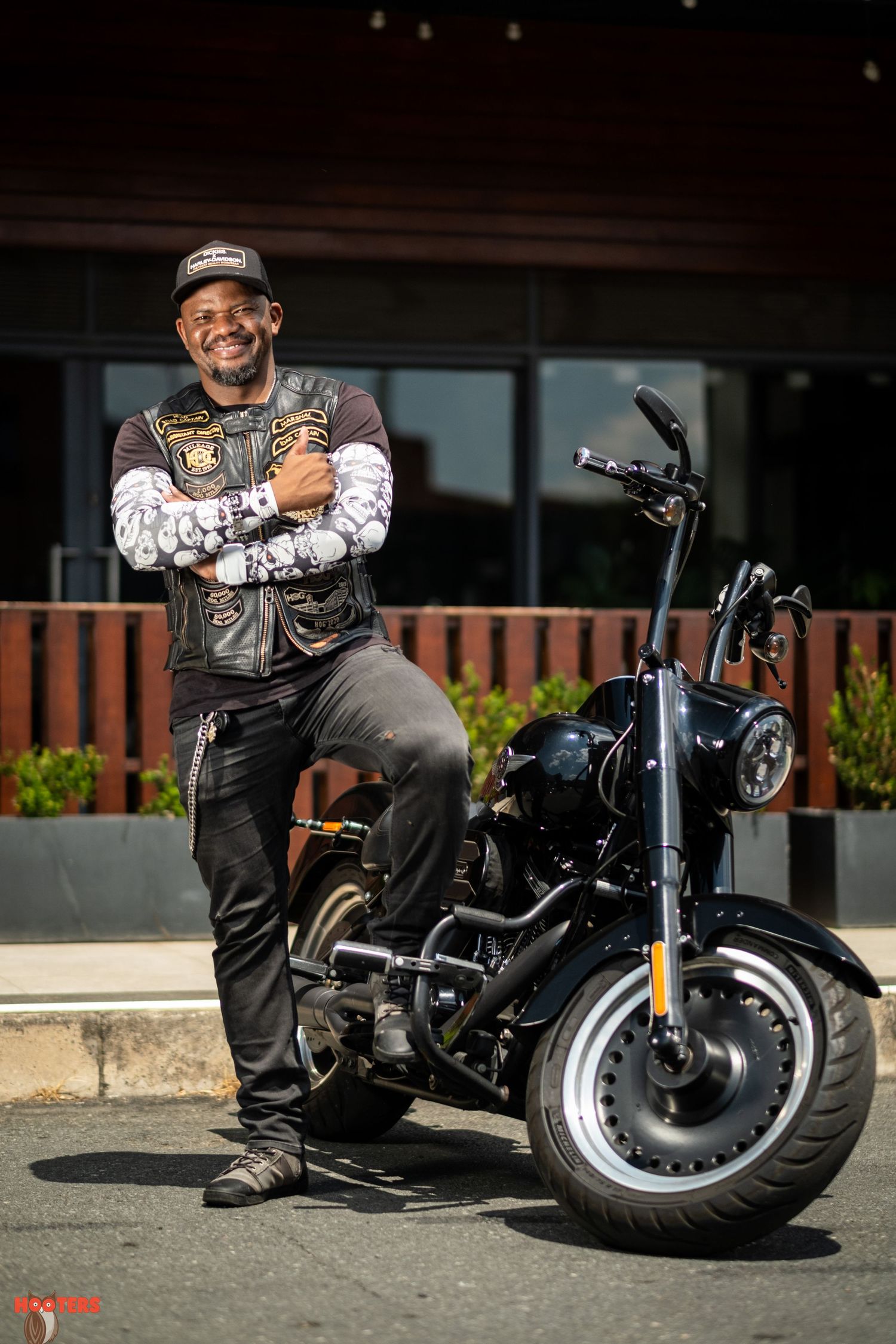 Custom motorcycle photoshoot featuring a black cruiser bike in an urban setting.