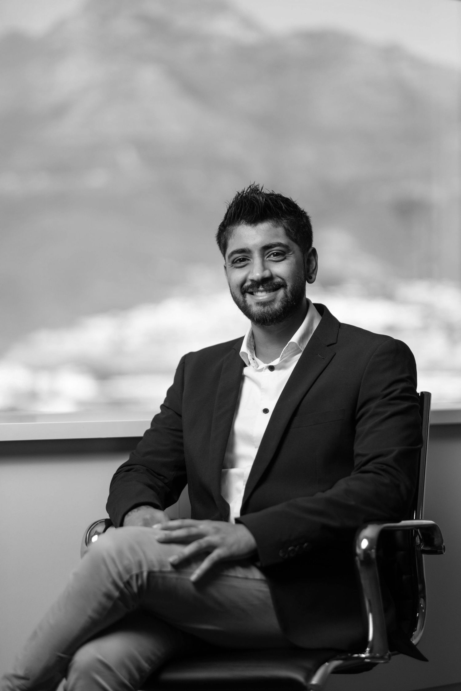 Black and white portrait series showing relaxed poses in business attire.