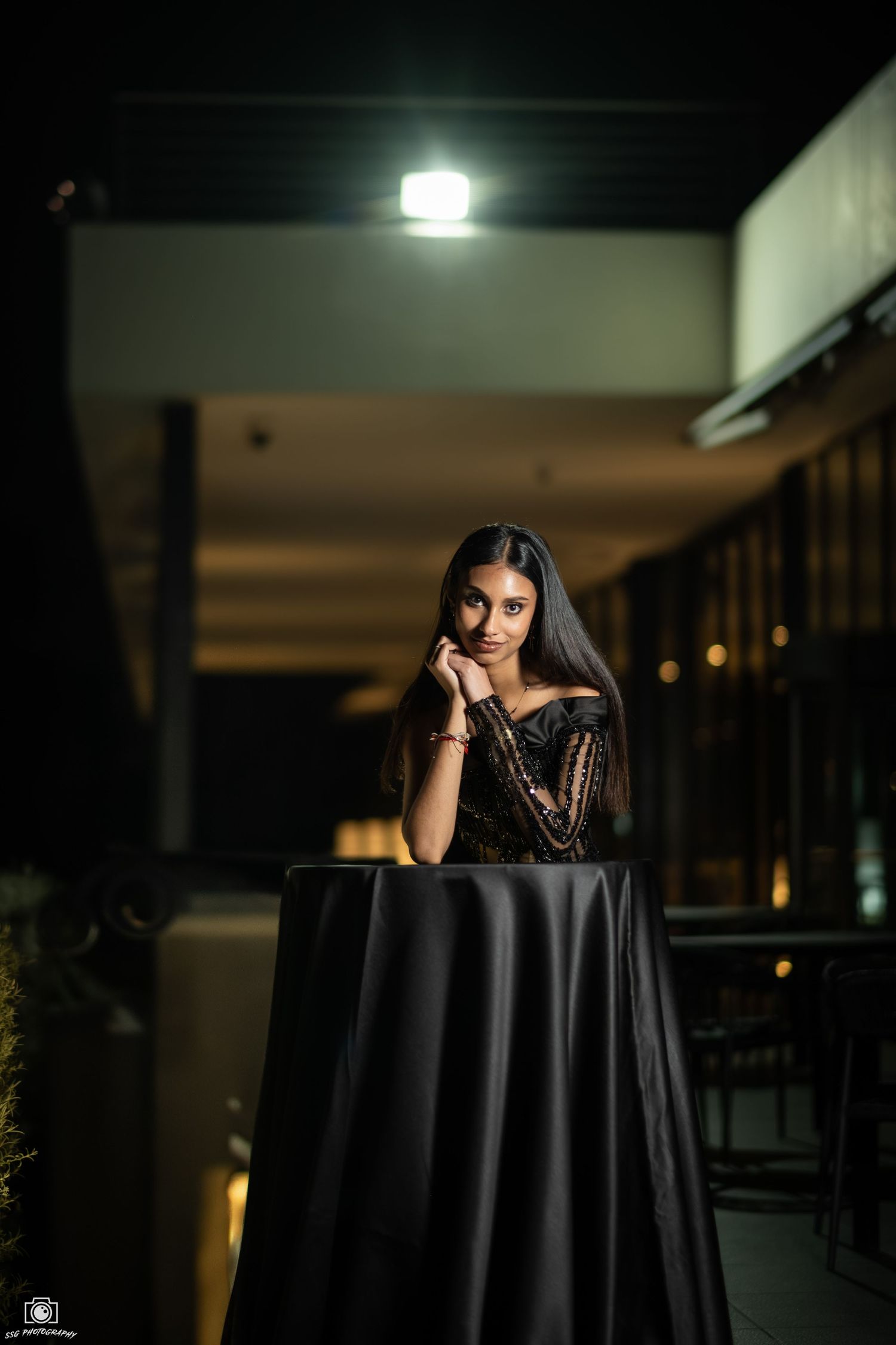 Elegant night photography with a black tablecloth and moody lighting.