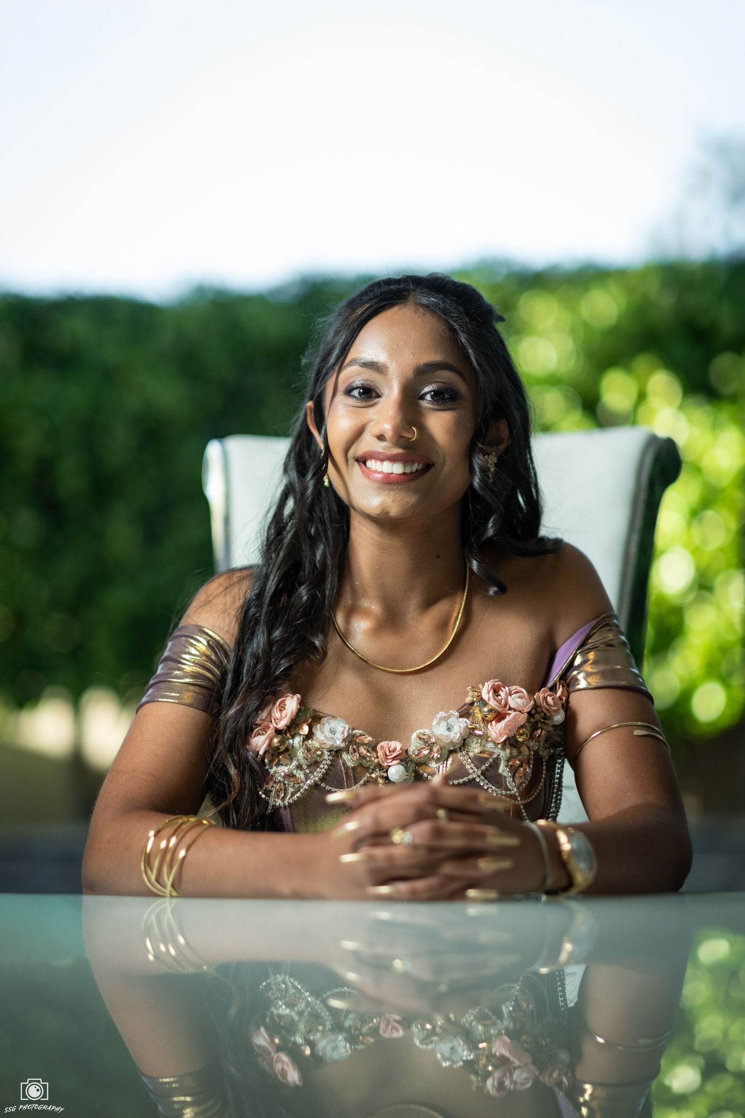 Portrait series of someone in floral dress resting on white furniture with outdoor greenery backdrop.