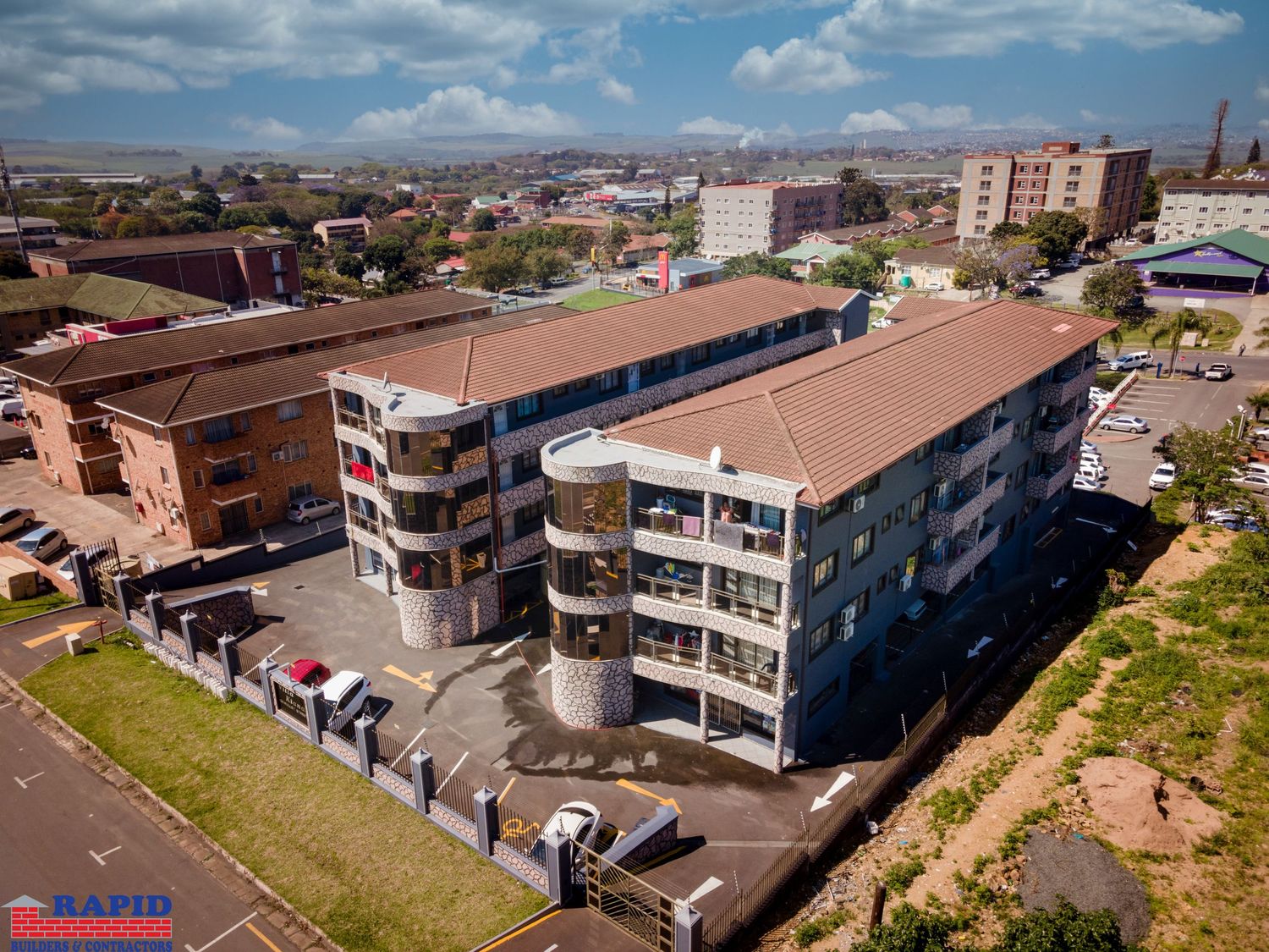 Aerial panorama of urban apartment buildings and streets in a residential neighborhood.