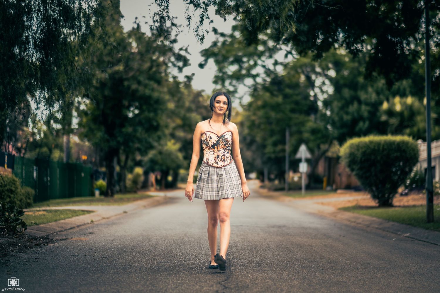 A long tree-lined pathway shot with shallow depth of field.