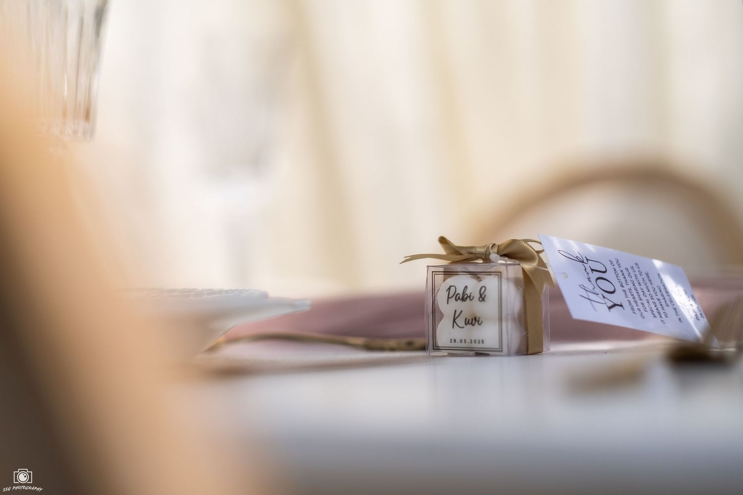 Close-up of elegant wedding stationery and decor details in soft focus.