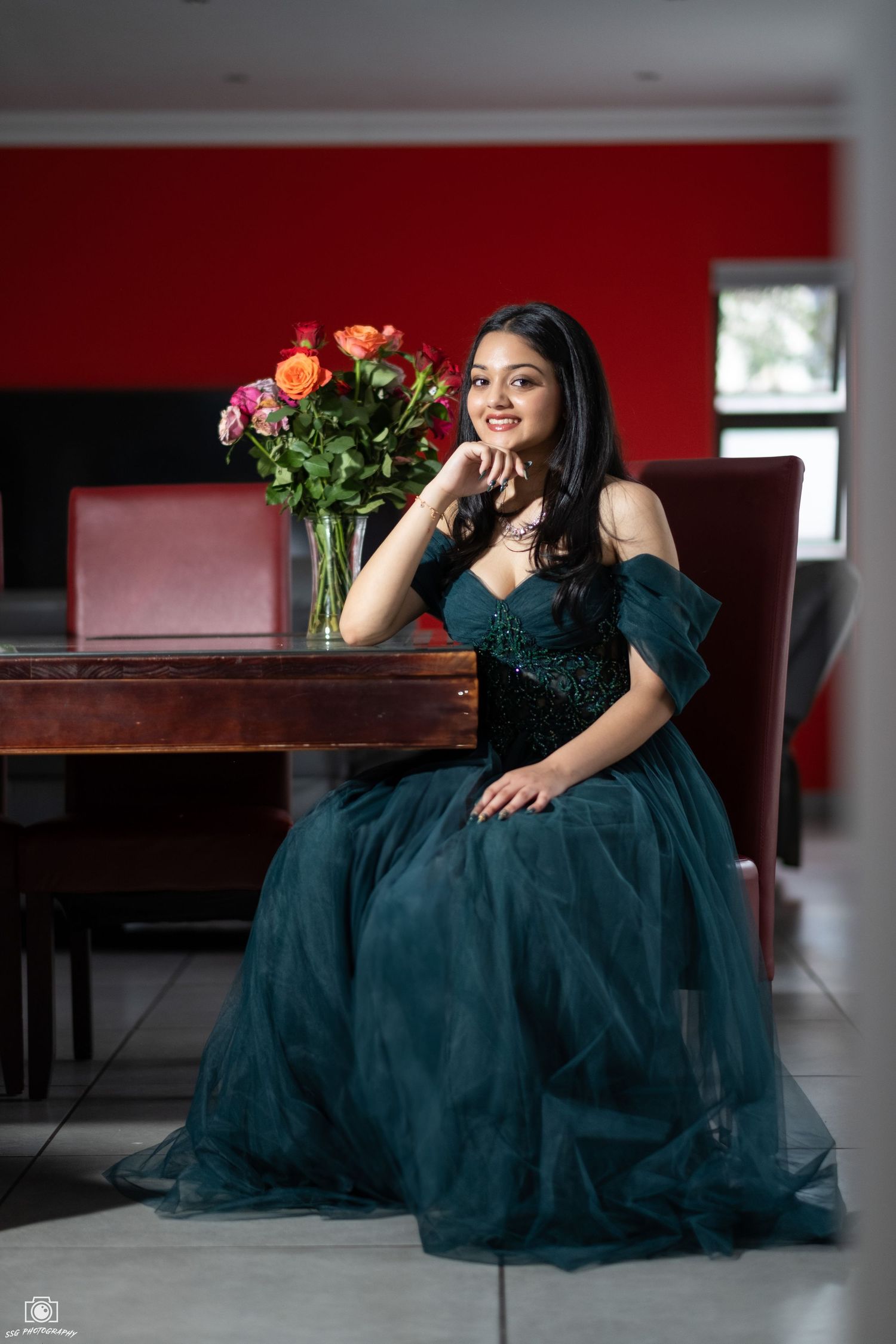 Elegant portrait series featuring person in dark teal evening gown with roses.