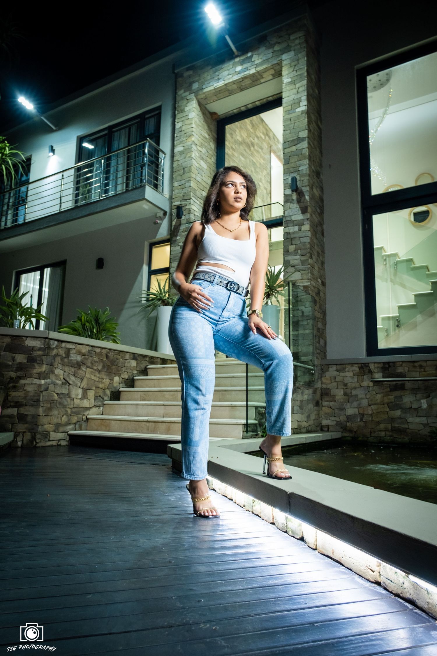 Night photography session on wooden deck with dramatic blue lighting.