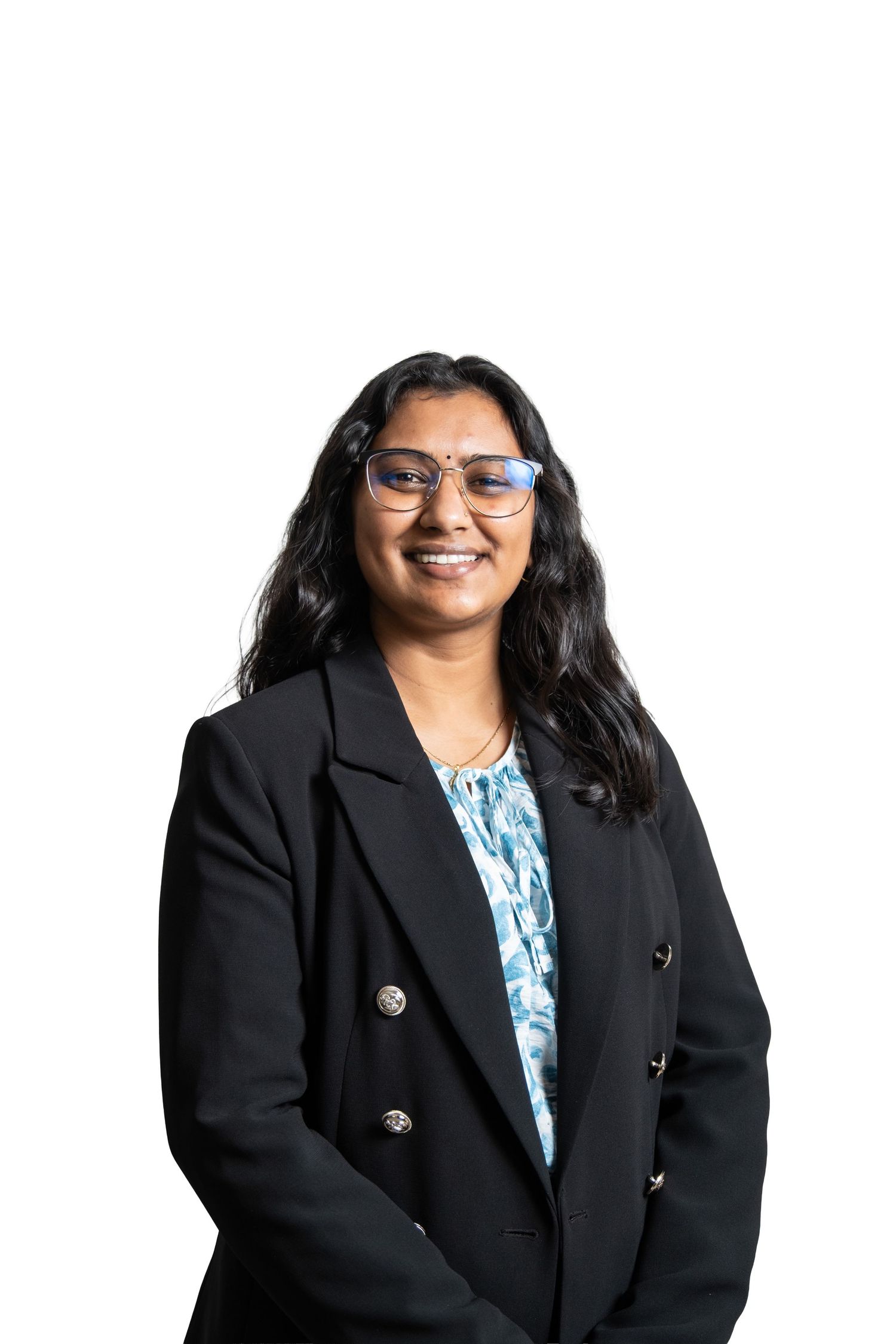 Professional wearing a black blazer and patterned blue top poses for a series of business headshots.