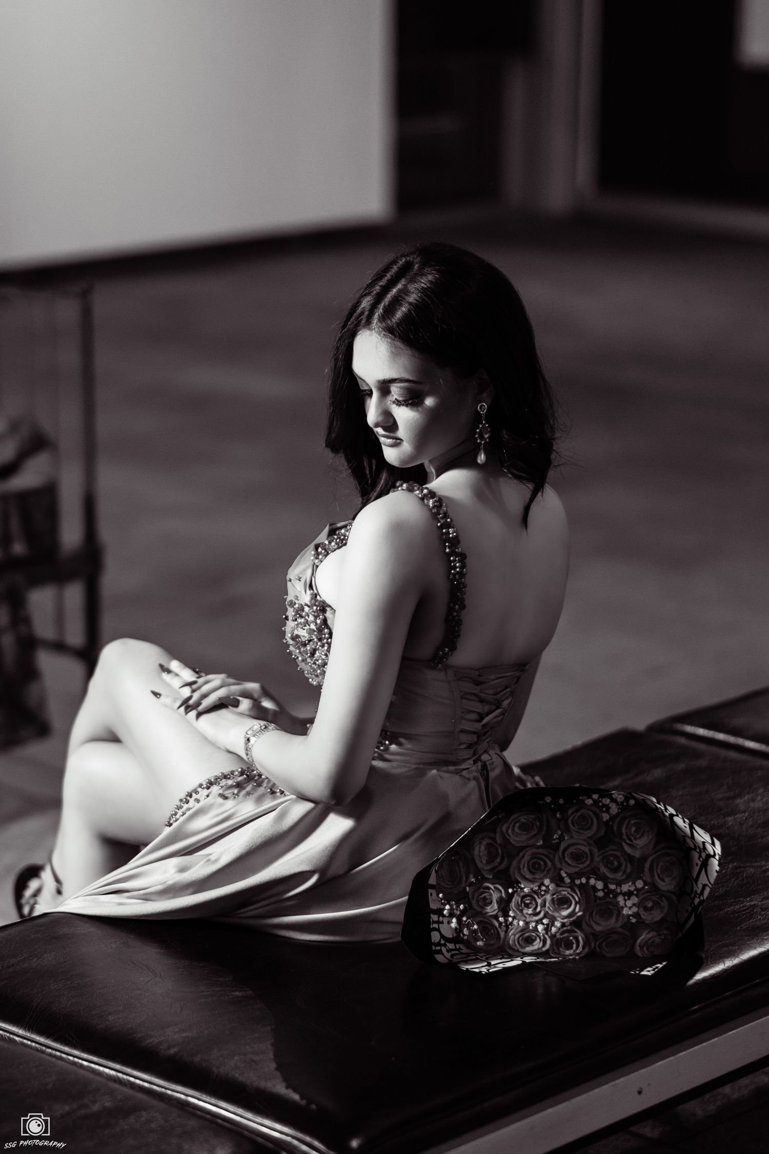 Artistic black and white boudoir photography with dramatic shadows and poses.