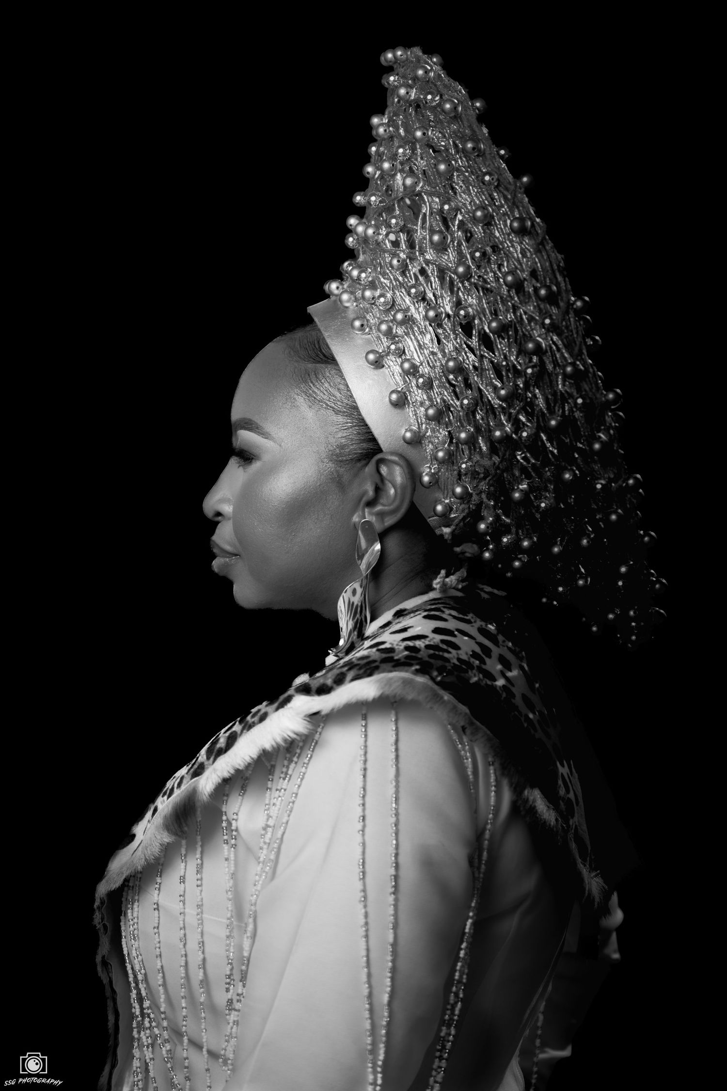 Dramatic black and white profile portraits showcasing an ornate beaded headdress.