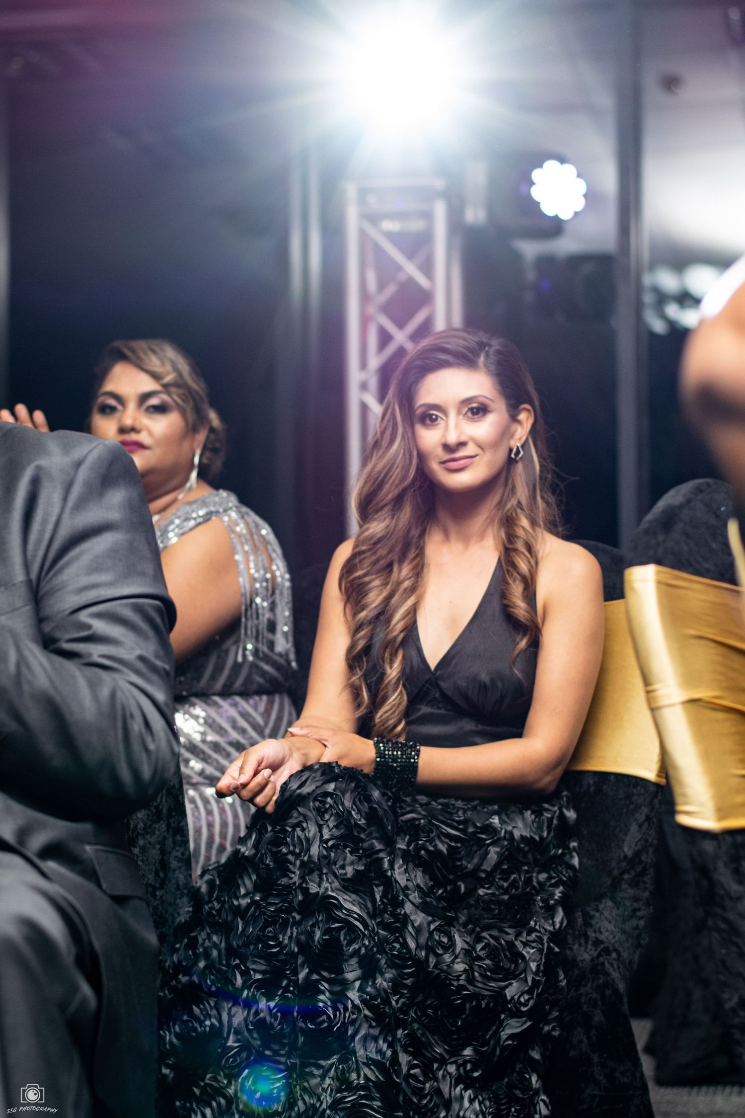 Glamorous event setting with dramatic lighting and elegant party decor.