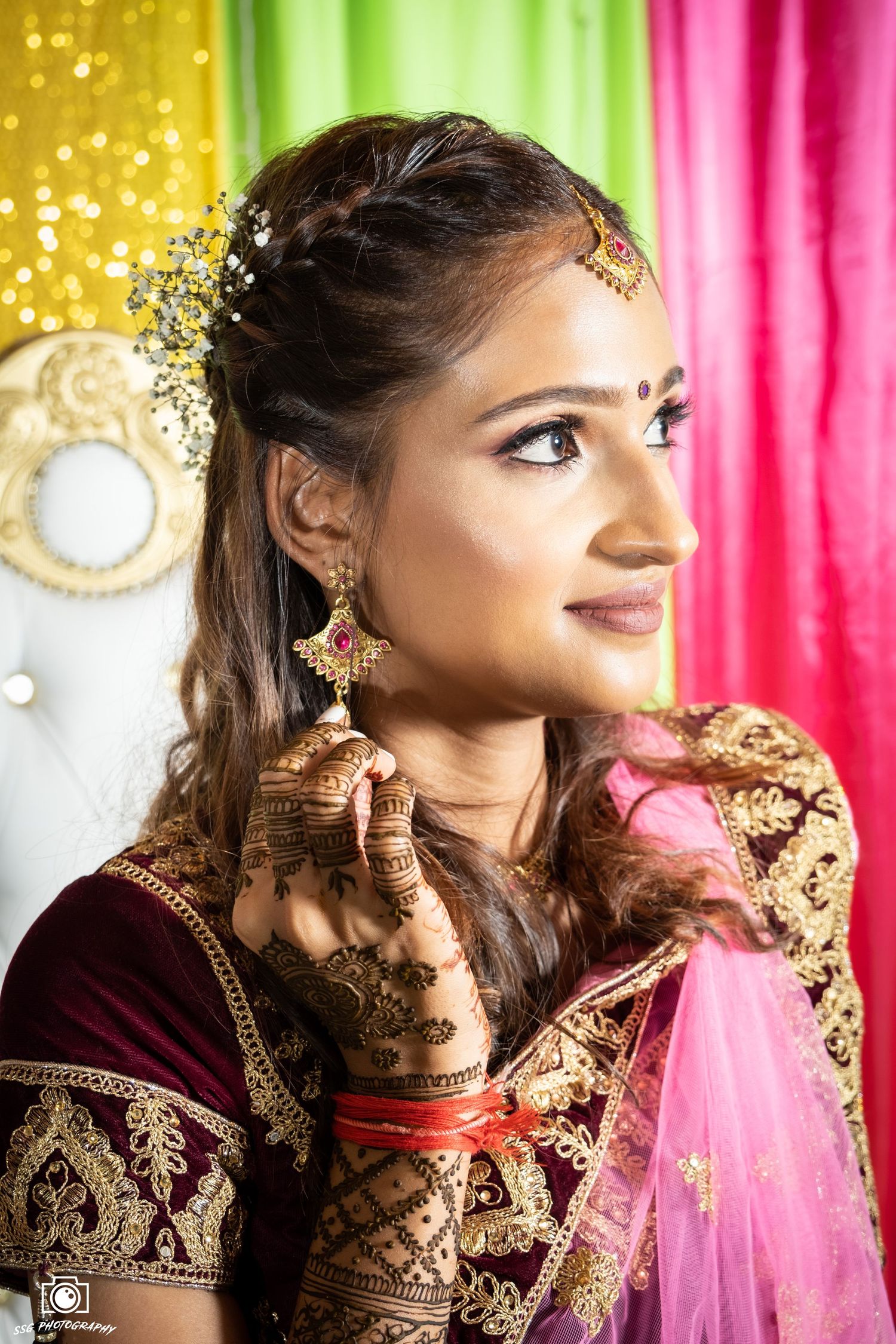 Traditional Indian bridal portraits with burgundy and pink attire against colorful backdrop.