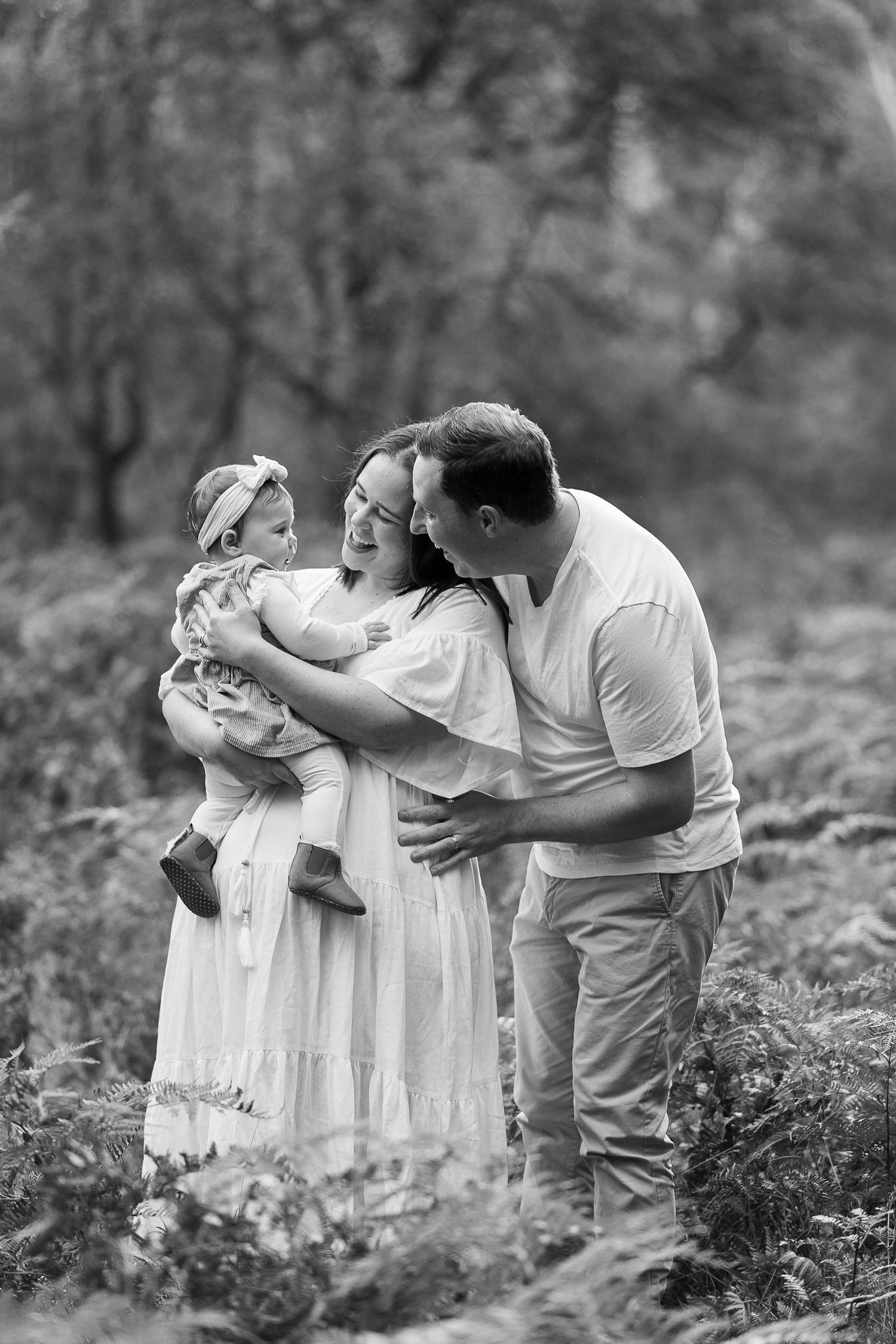 Family sharing emotional moment together in black and white photography.