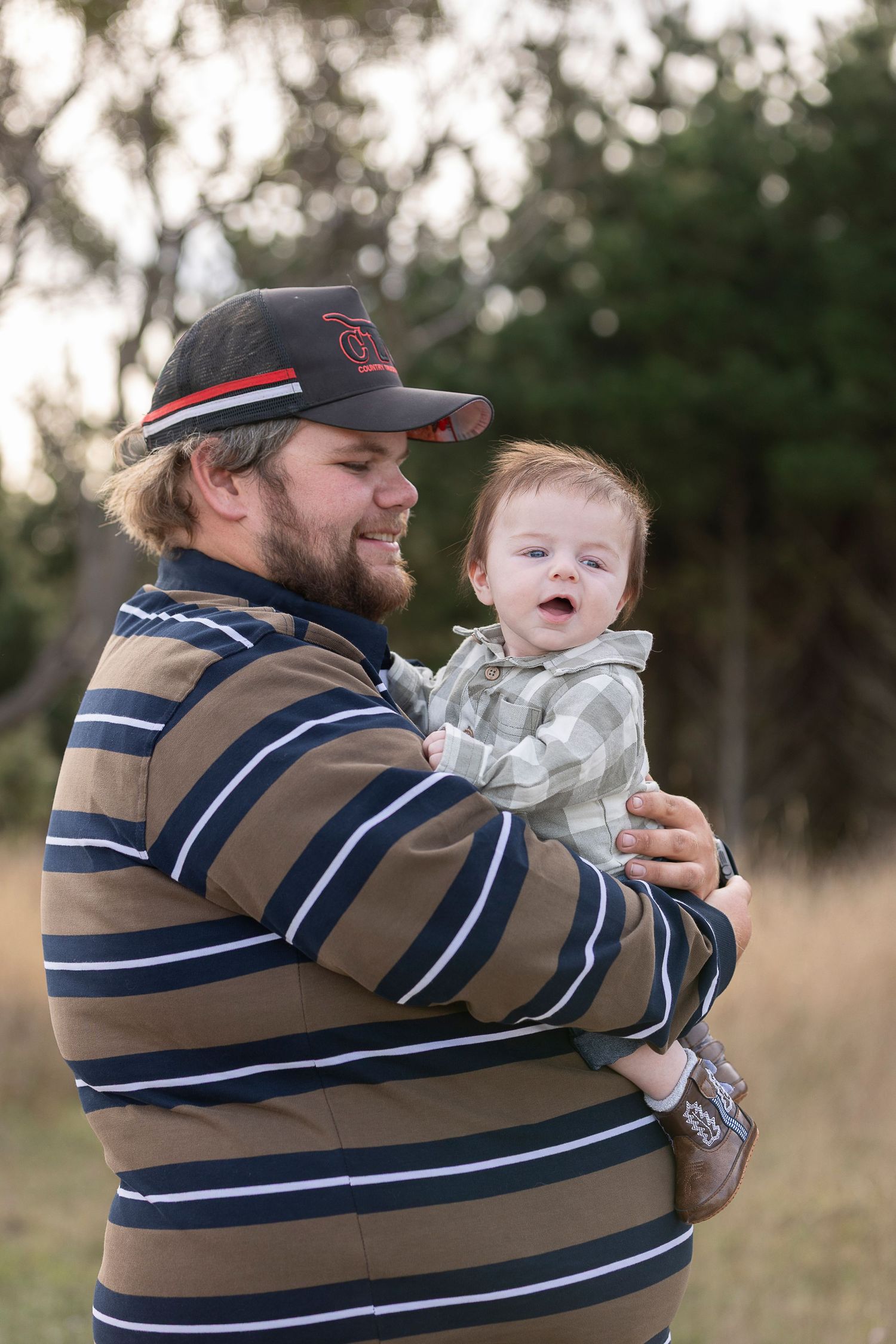 Playful outdoor sequence showing joyful moments between adult and baby in casual wear.