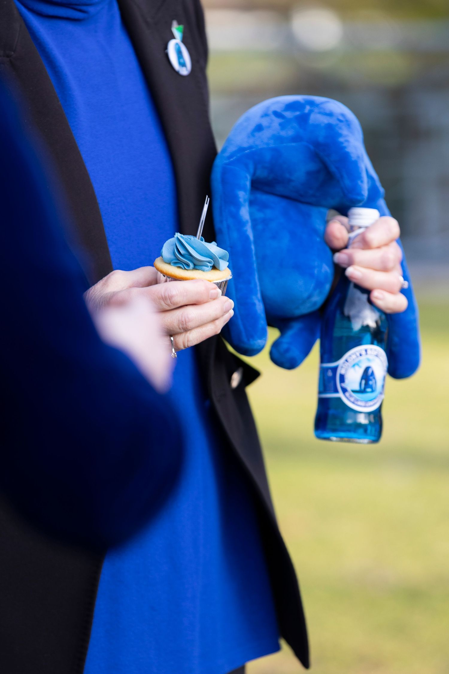 Close-up details of handling blue fabric or material during an art installation.