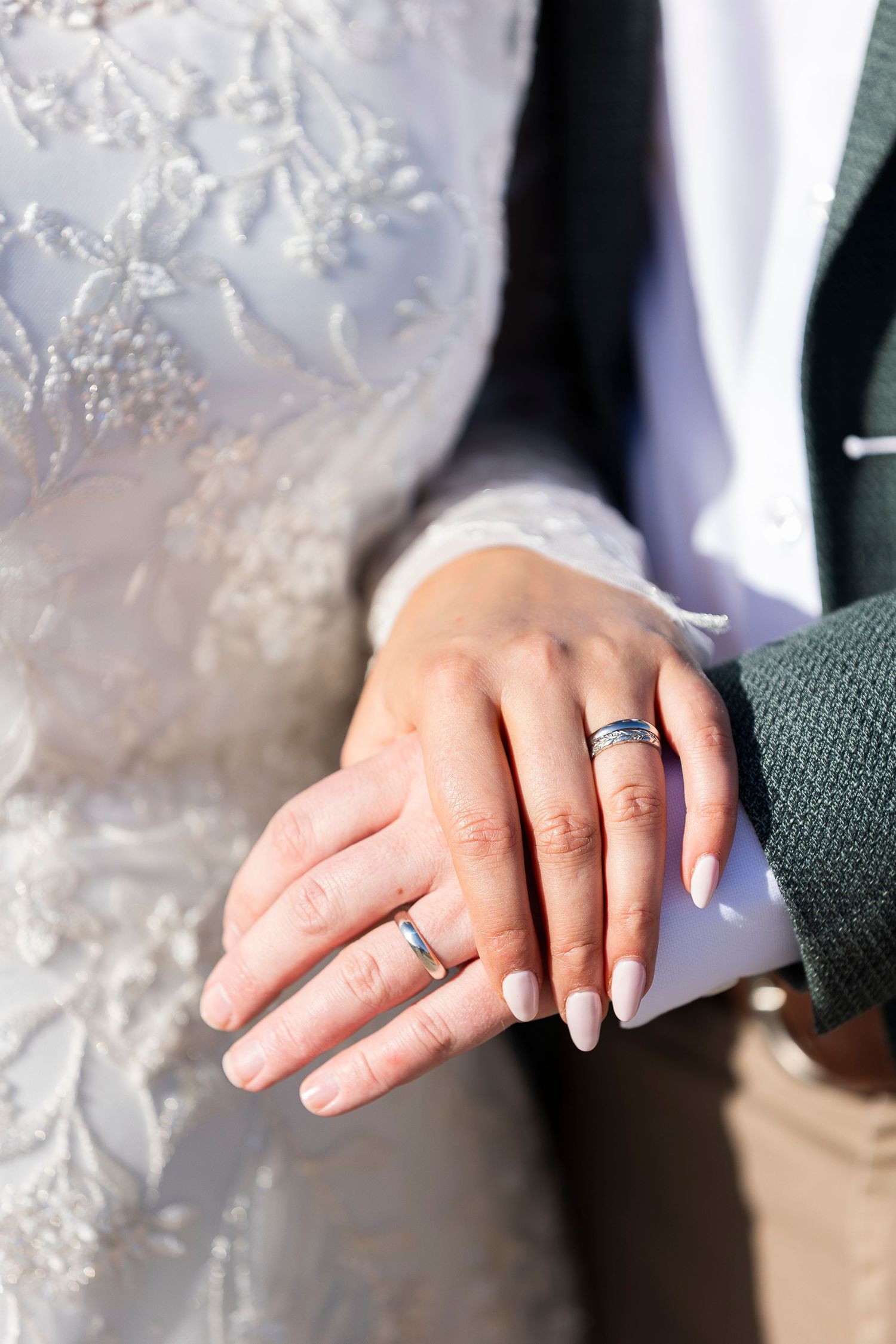 Close-up sequence of wedding rings and hands showing newly married couple's jewelry.