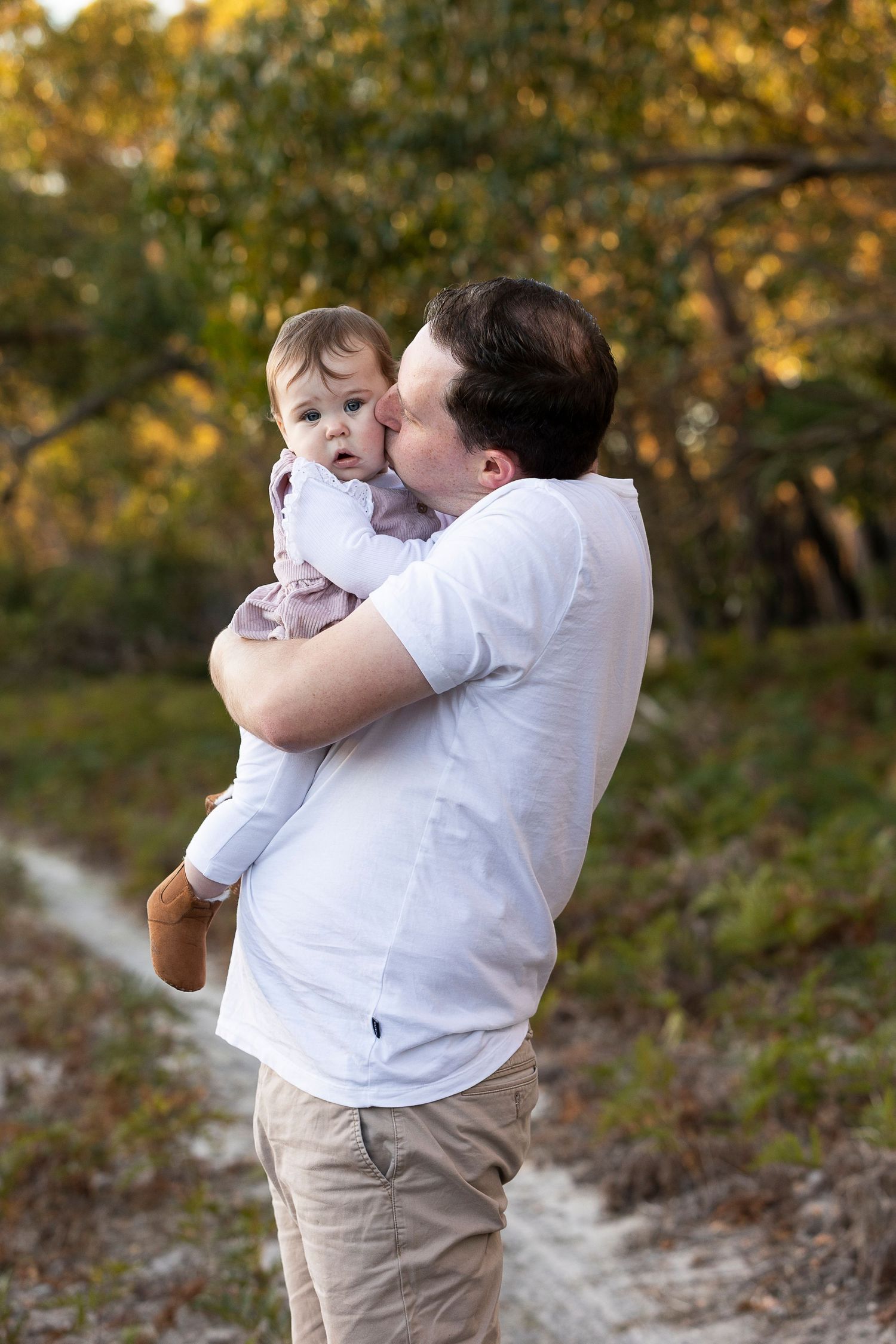 A tender moment between parent and child outdoors in autumn.