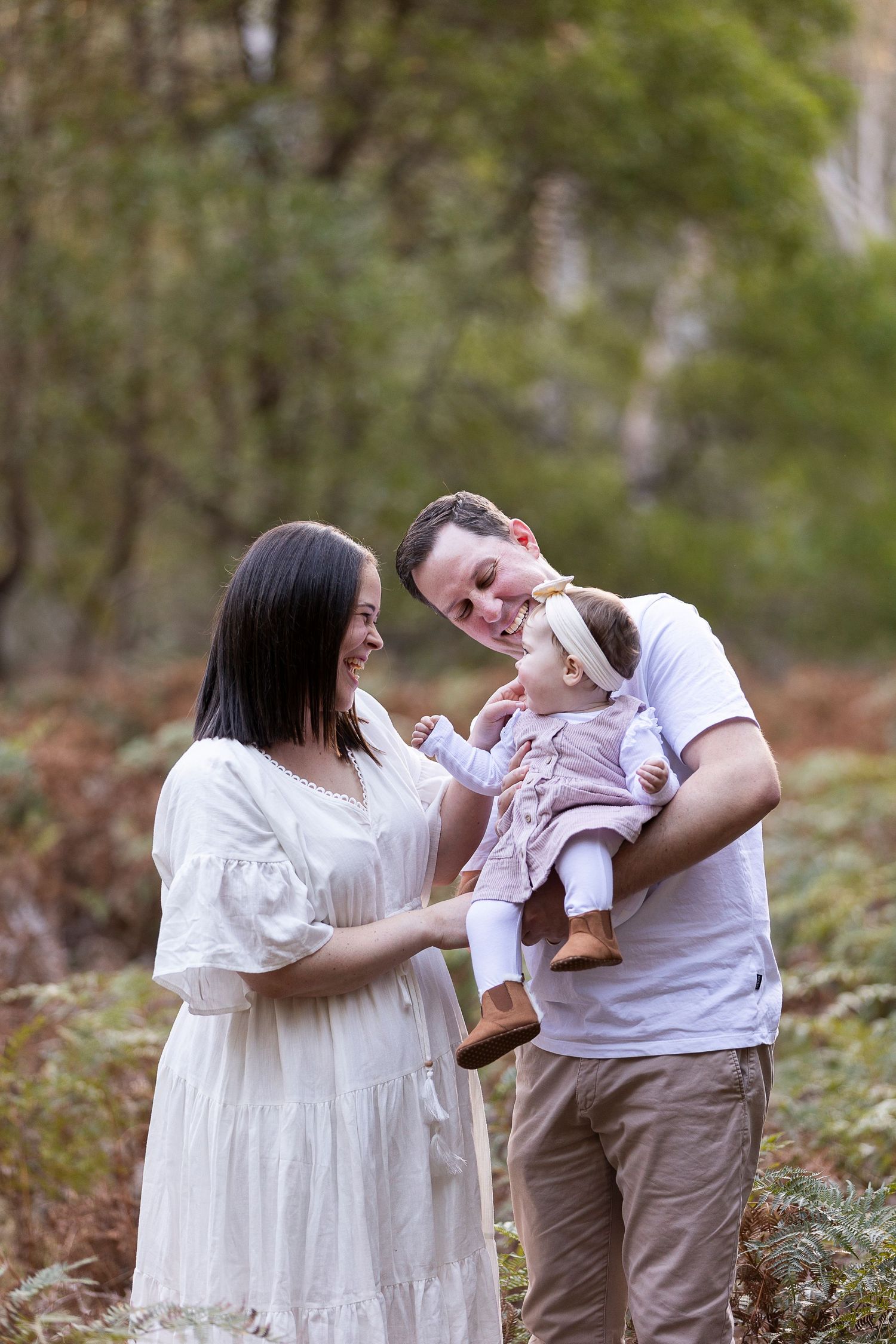 Family sharing a tender moment together outdoors in a natural setting.