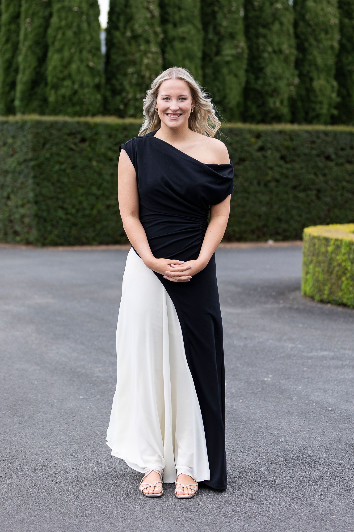 Contrasting black and white formal dresses photographed outdoors.
