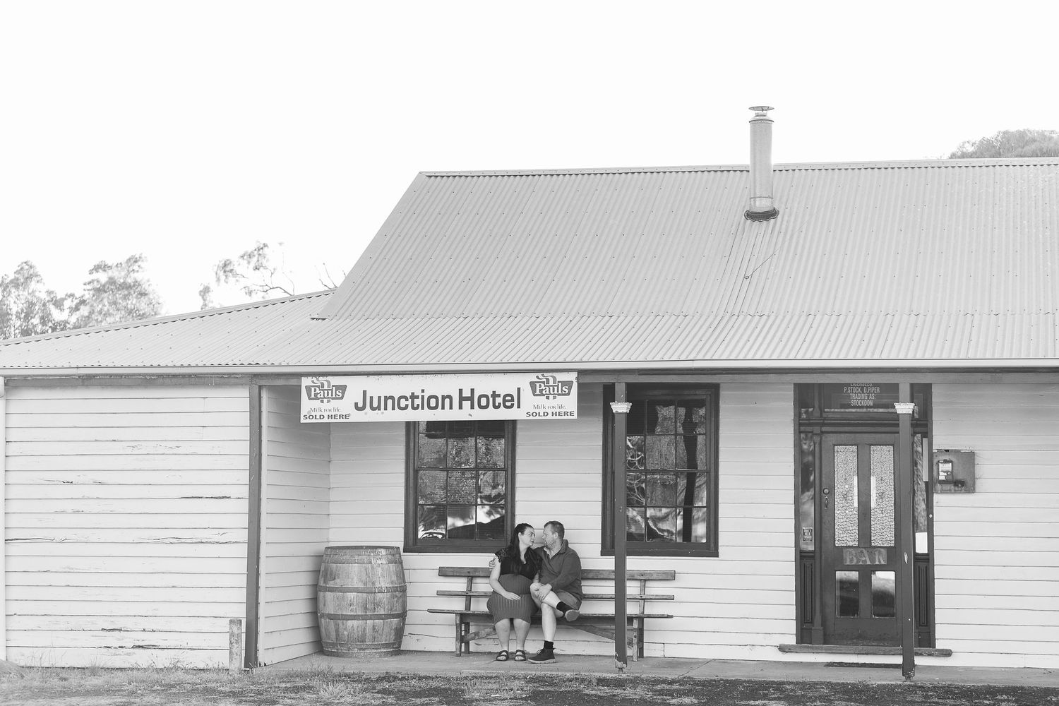 Black and white panoramic view of vintage storefronts and buildings.