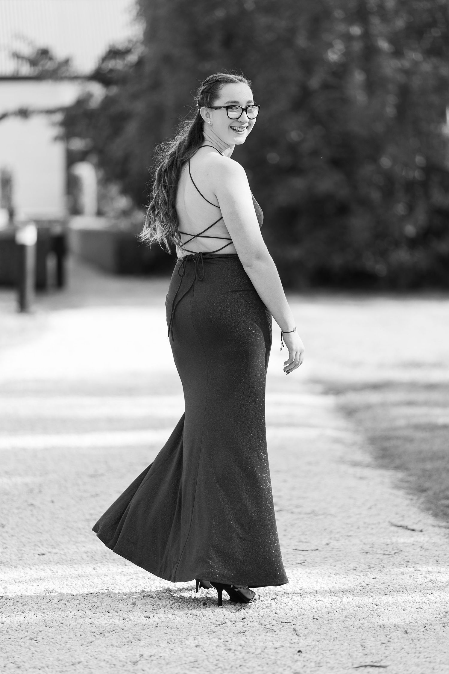 A series of black and white portraits showing a person in a flowing black dress twirling outdoors.