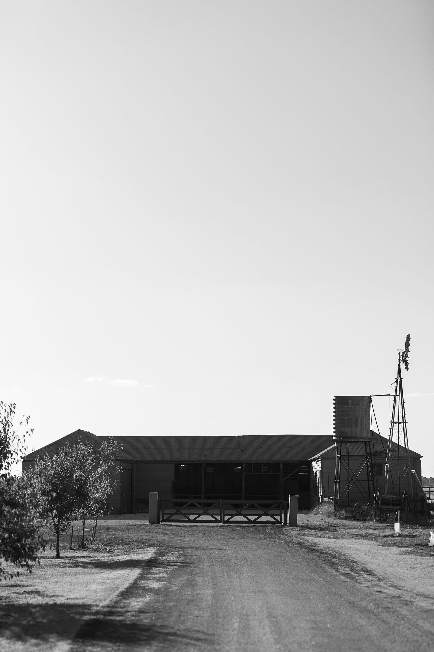 Black and white panorama of rural farm buildings and structures.