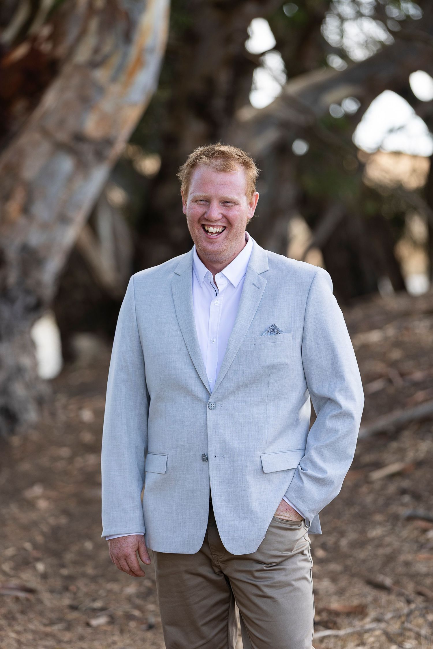 A series of portrait shots showing someone in a light colored suit jacket and khaki pants outdoors.