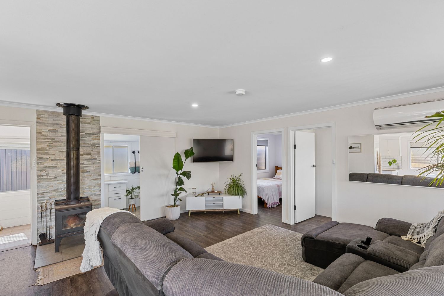 Contemporary living room with grey sectional sofa and modern fireplace.