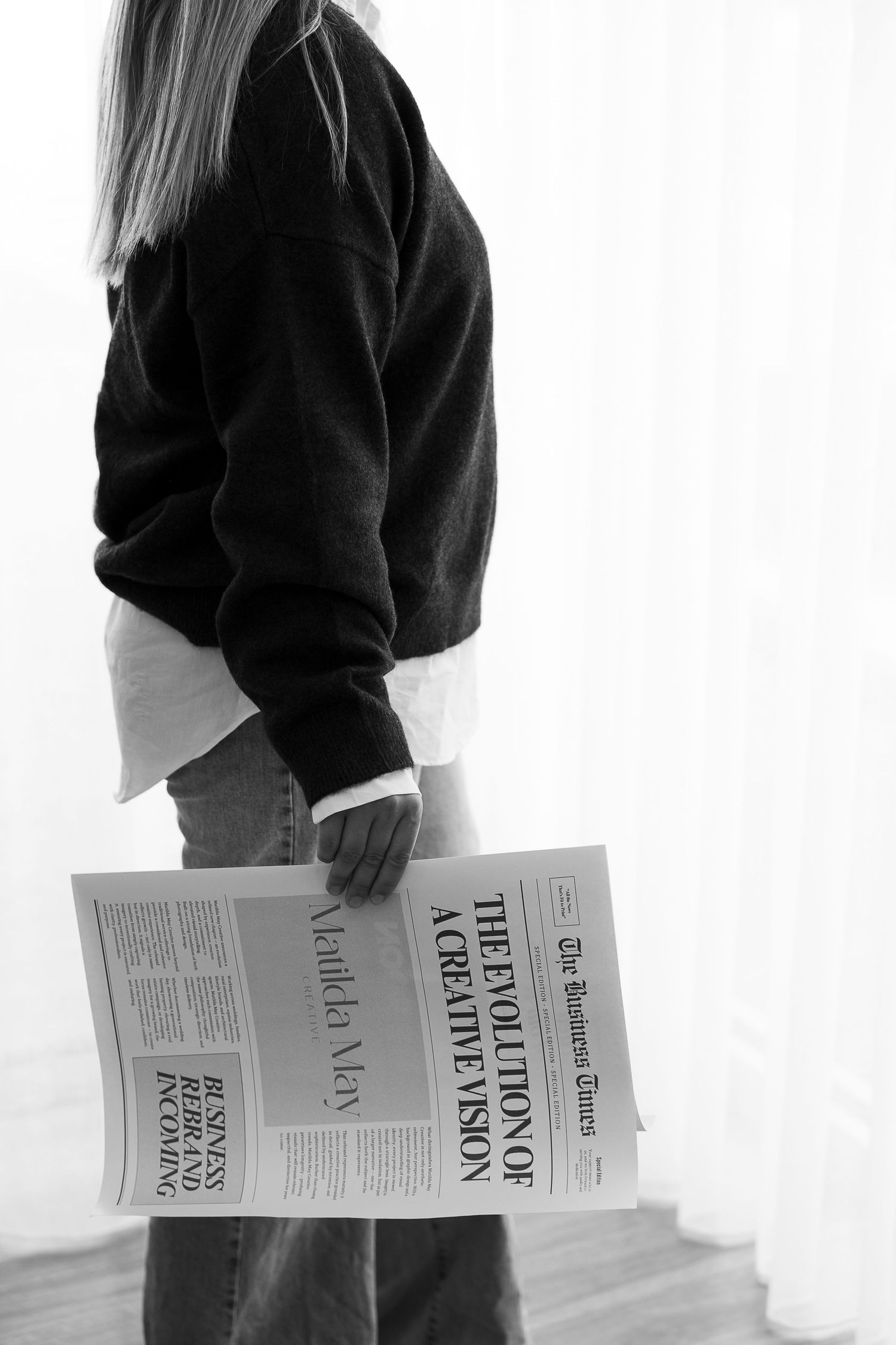 A person wearing a black sweater holds and flips through multiple sheets of paper in a sequence of images.