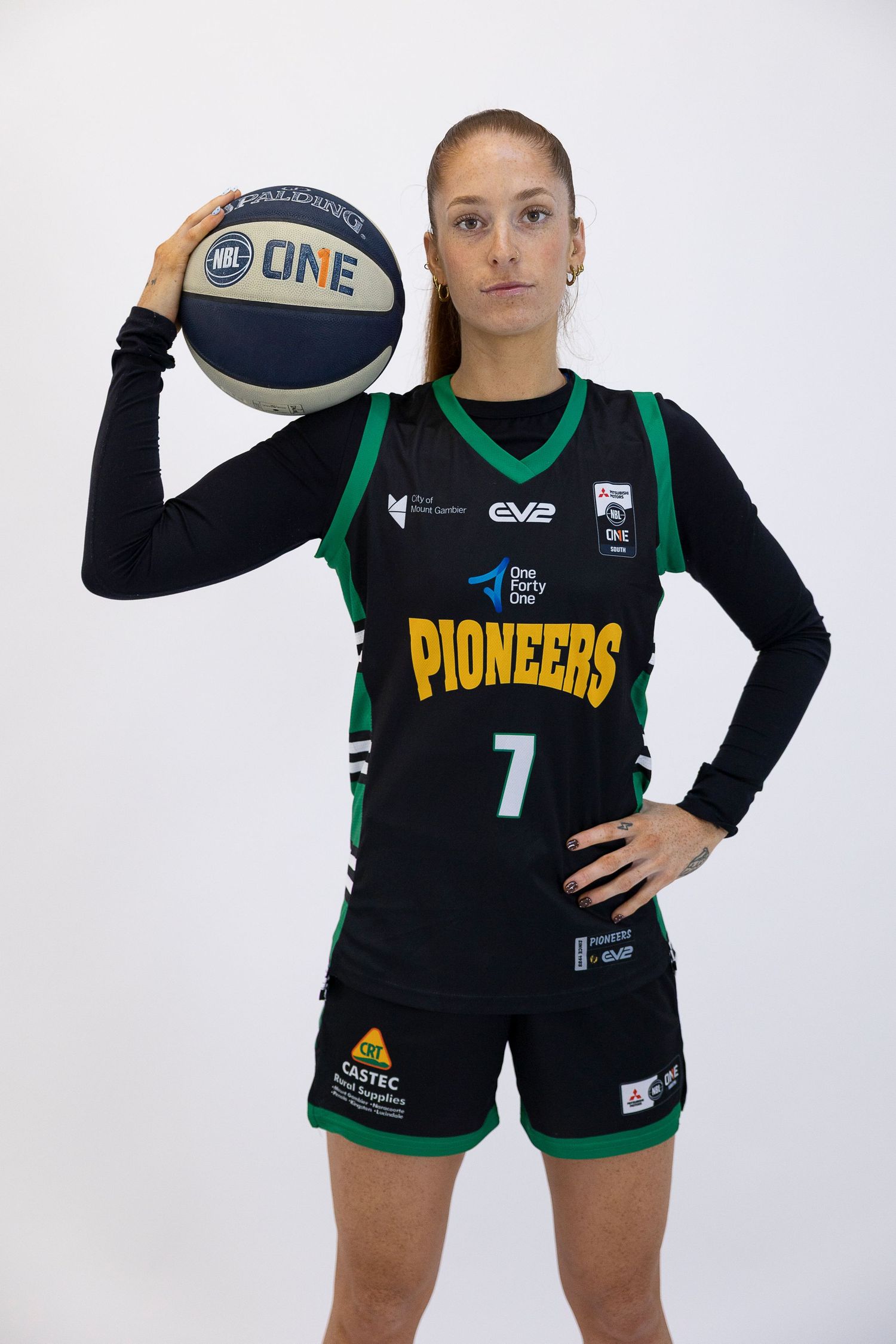 Female basketball player in black Pioneers #7 jersey holding a ball, posing for official team photo.