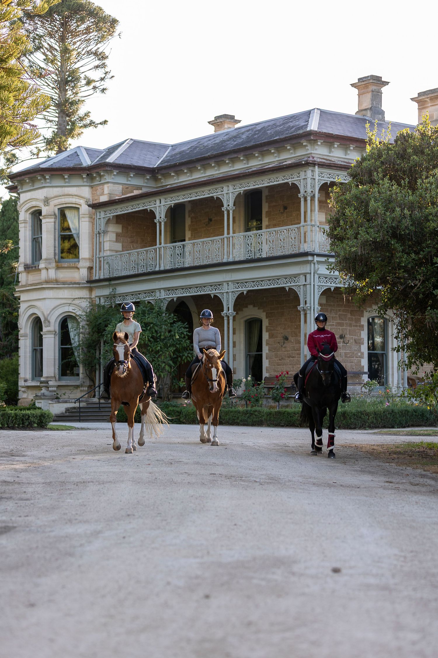 Multiple views of horses and riders in front of a grand historic estate building.
