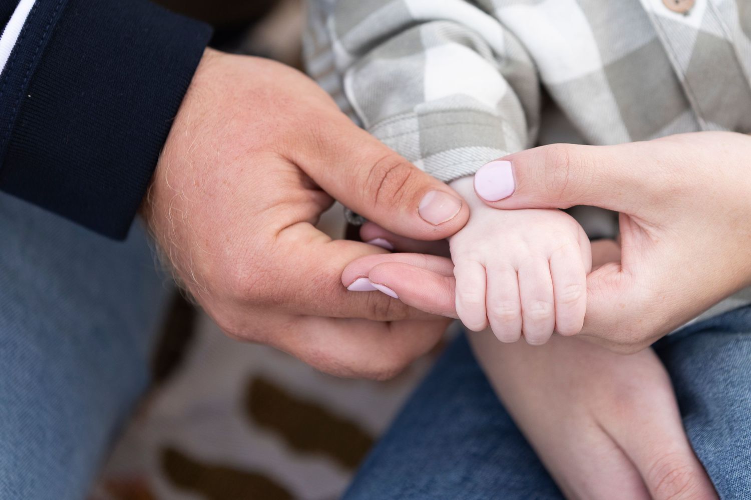 Close-up sequence of hands gently touching and holding each other.