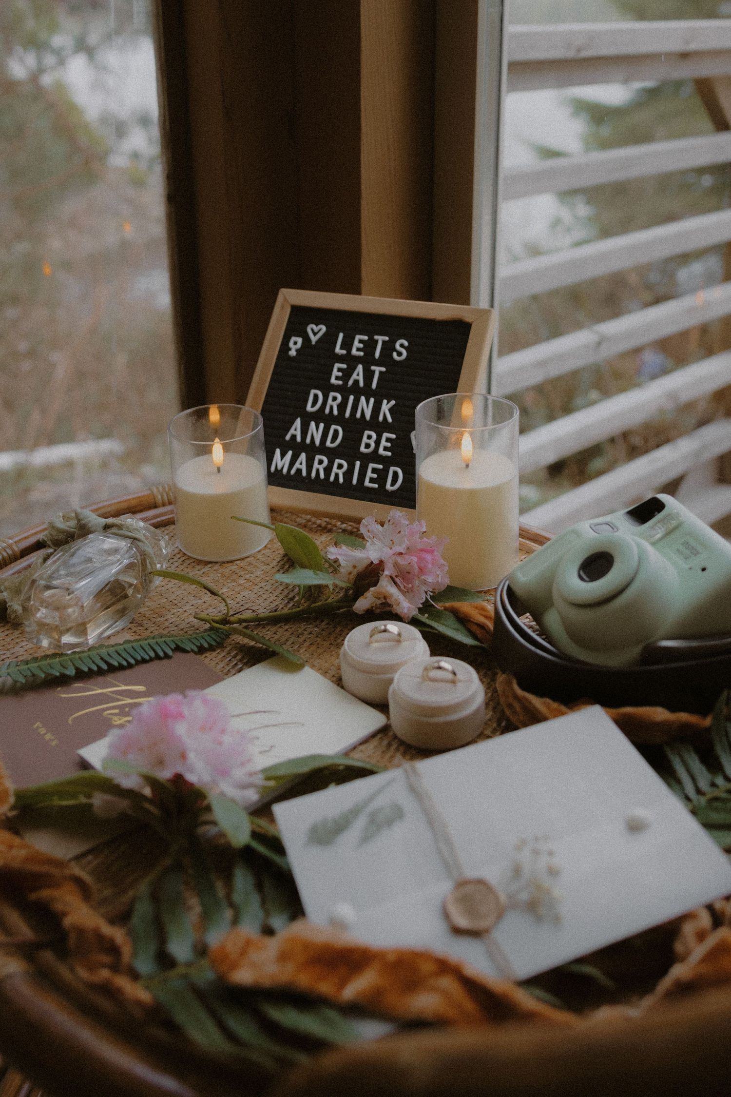 Tofino wedding detail flat lay with flowers and handwritten notes on rustic wooden surface