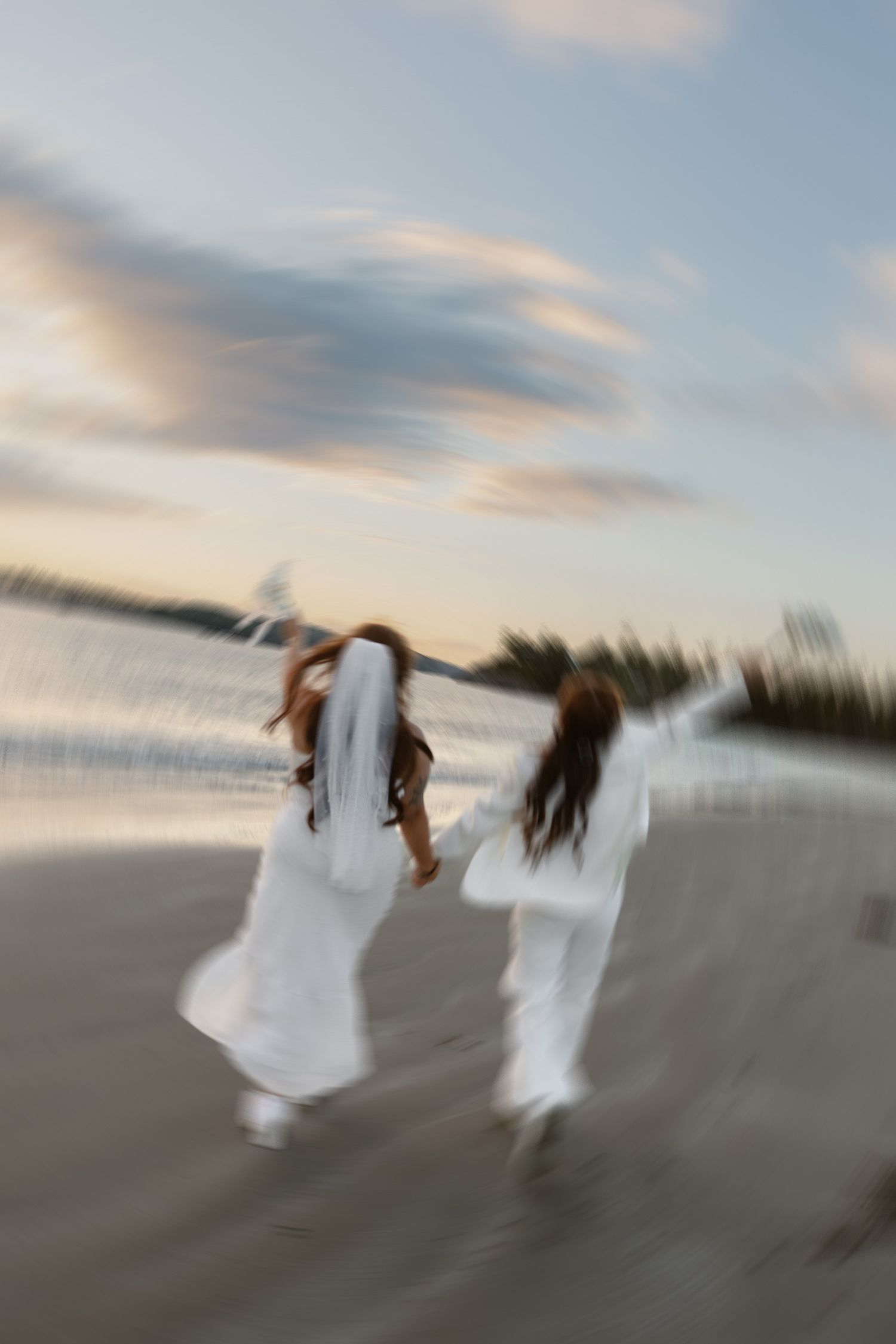 Vancouver Island golden hour elopement brides dancing on a beach at sunset