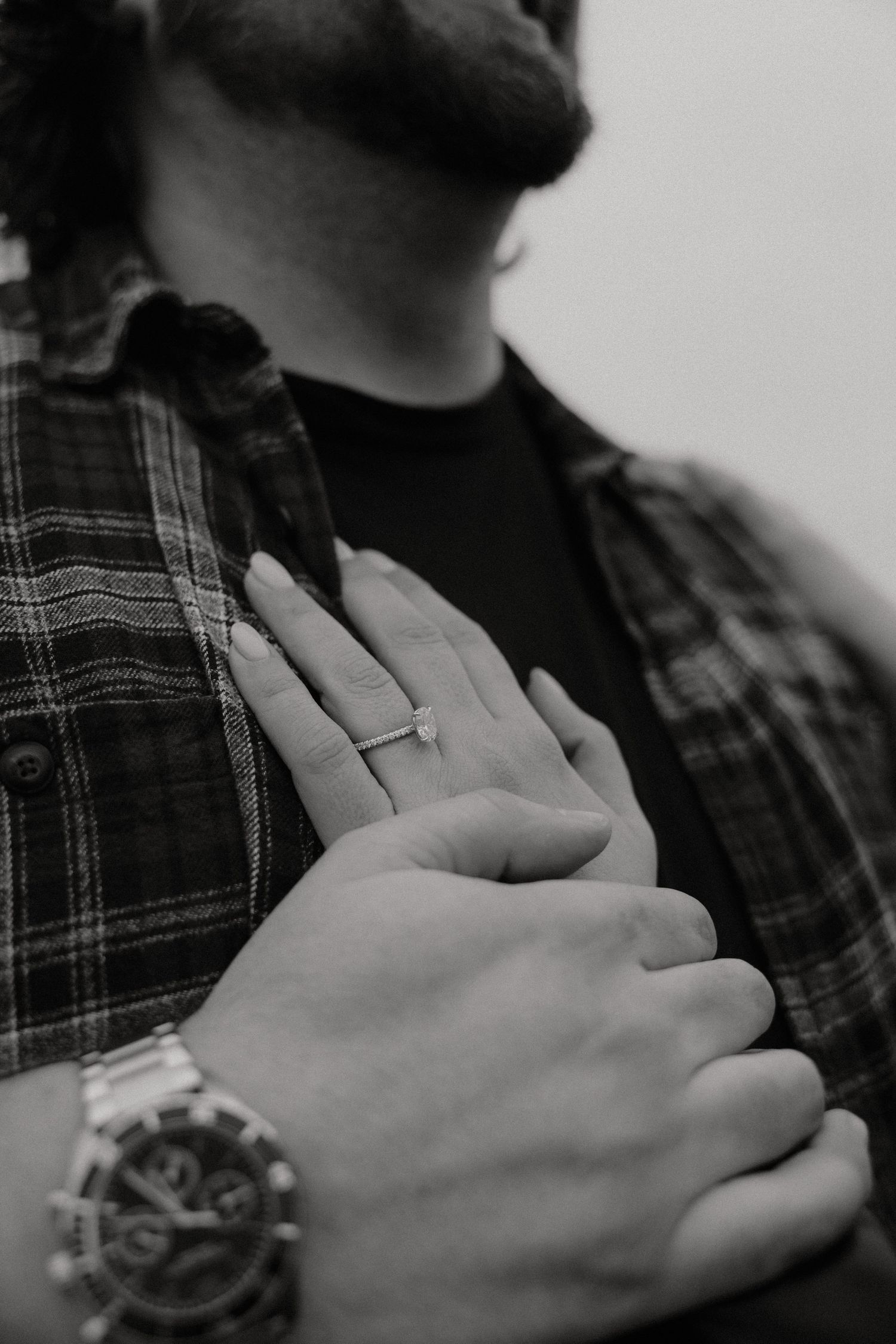Tofino wedding black and white close-up of hands resting on plaid shirt fabric